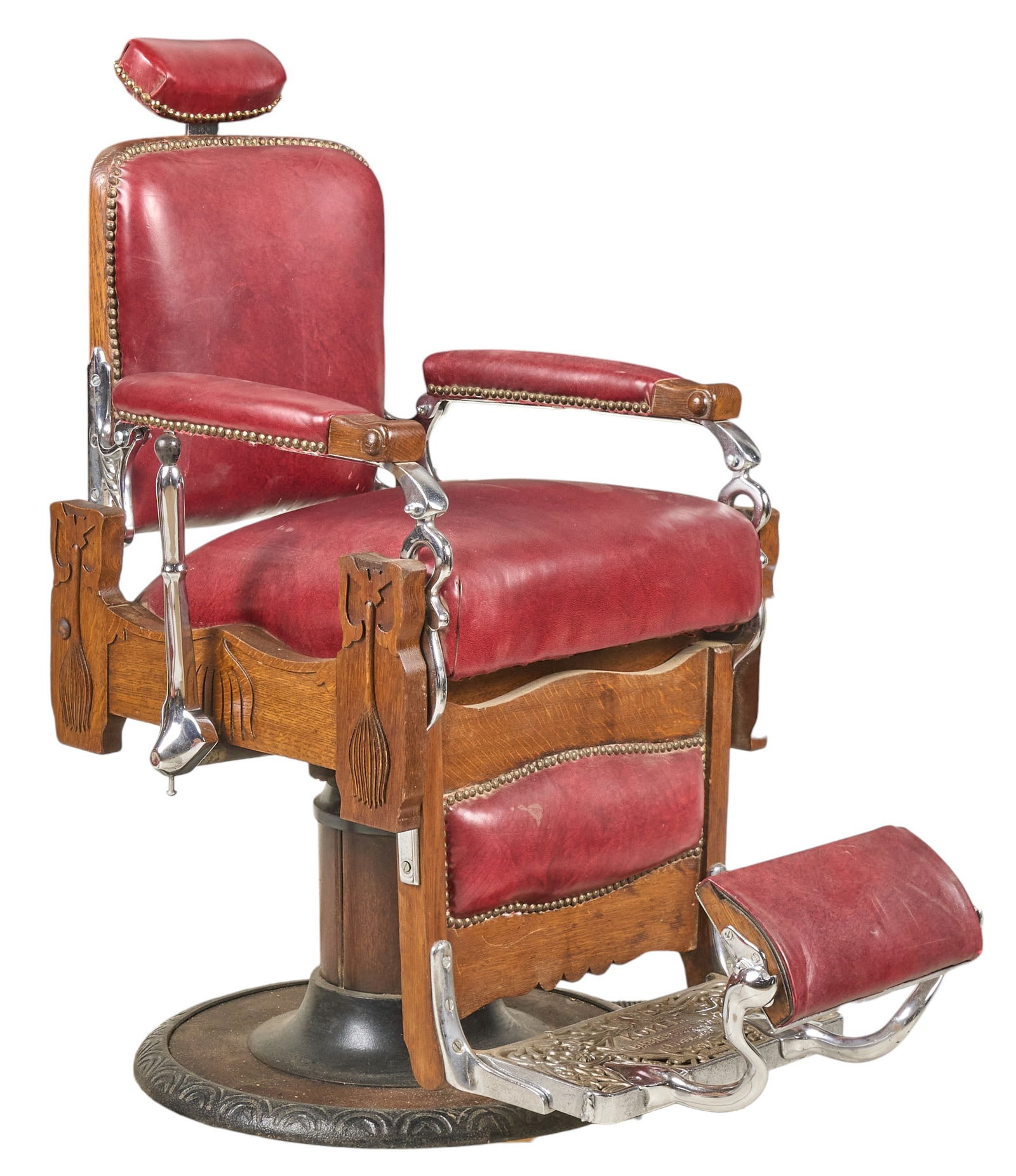 Koken Barbers' Supply Co. Barber Chair: Vintage Koken Barbers' Supply Co. barber chair with red leather upholstery, wooden frame with decorative carvings, and chrome accents, circa 1890sheight 46 in. x width 27 in. x depth 42