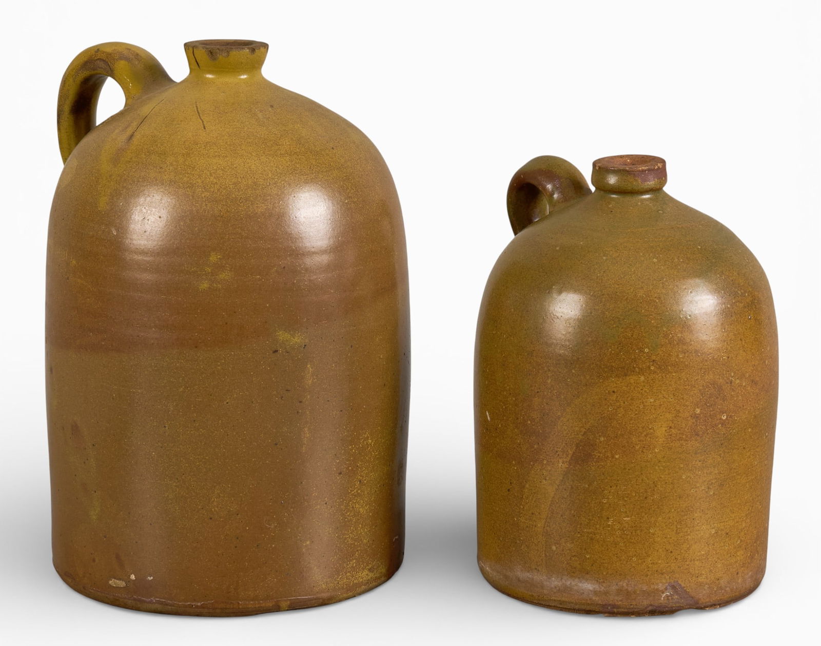 (2) Meyer Jugs: Two Meyer stoneware jugs with handlesheight 12.5 in. x width 7.5 in. x depth 8 in. / largest Provenance: Property from a home in Austin, Texas