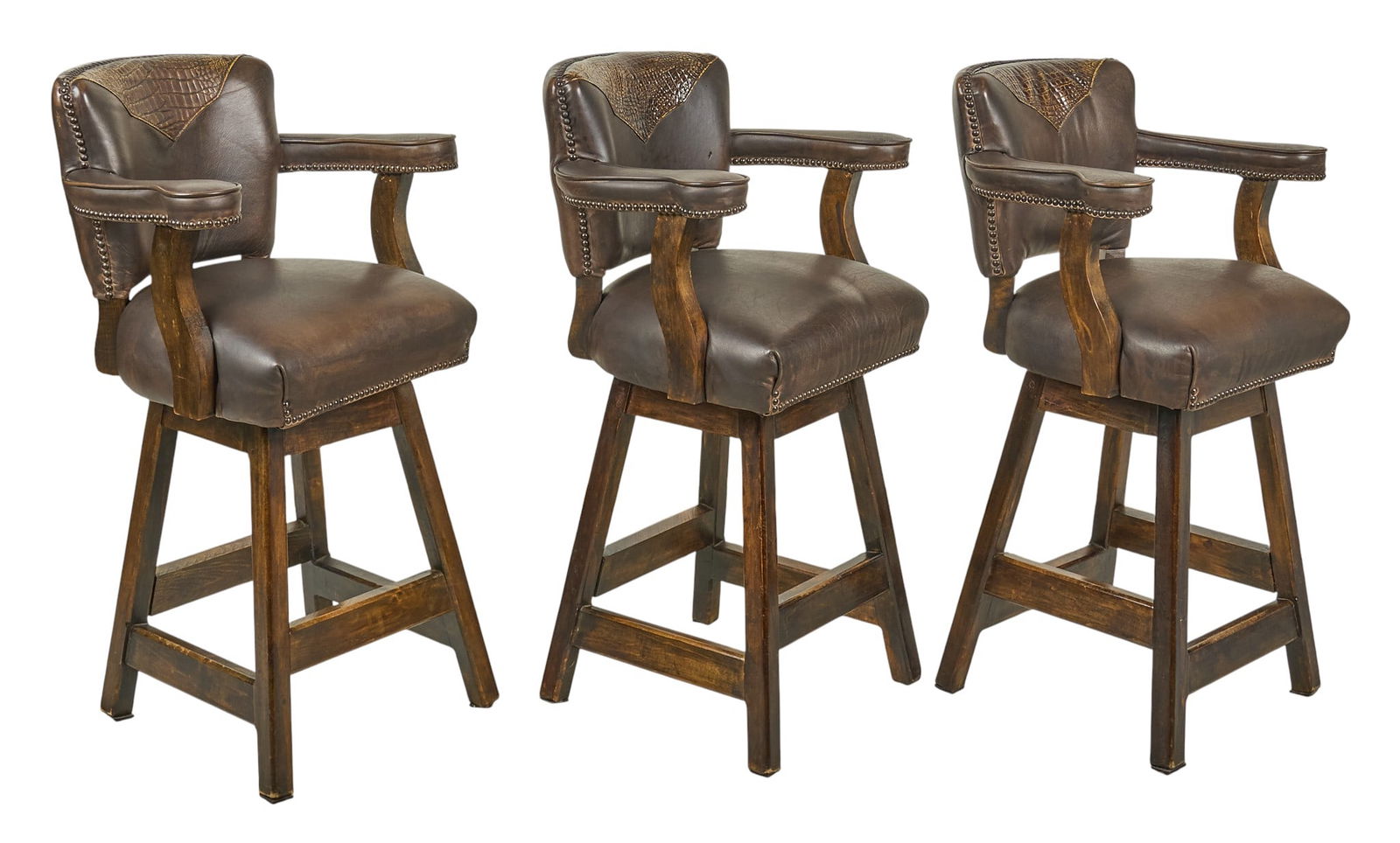 (3) Alligator and Leather Bartstools: Set of three ranch style barstool chairs brown leather upholstery with alligator accents, supported on wooden swivel bases height 44 in. x width 22 in. x depth 26 in. / each Provenance: Property from