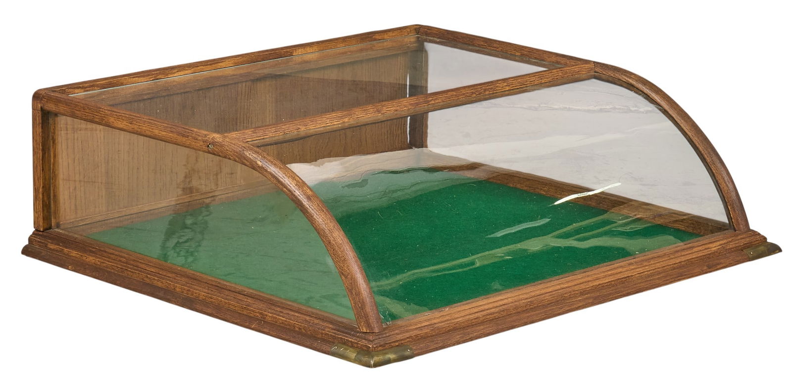 Vintage General Store Glass Showcase: Vintage general store glass showcase with green felt lining, and curved glassheight 9.5 in. x width 31 in. x depth 27 in. Provenance: Property from a home in San Antonio, Texas