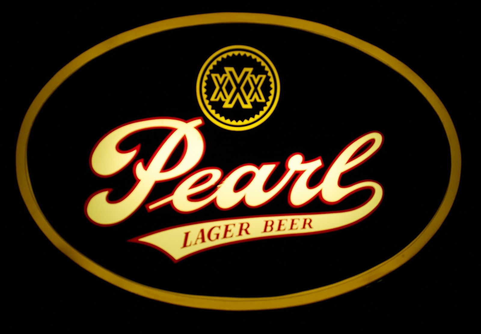 Pearl Lighted Black Oval Sign, 1980: Vintage Pearl Lager Beer lighted plastic box sign, in working condition, circa 1980sheight 12 in. x width 19 in. x depth 3 in. Provenance: Property from a home in Seguin, Texas