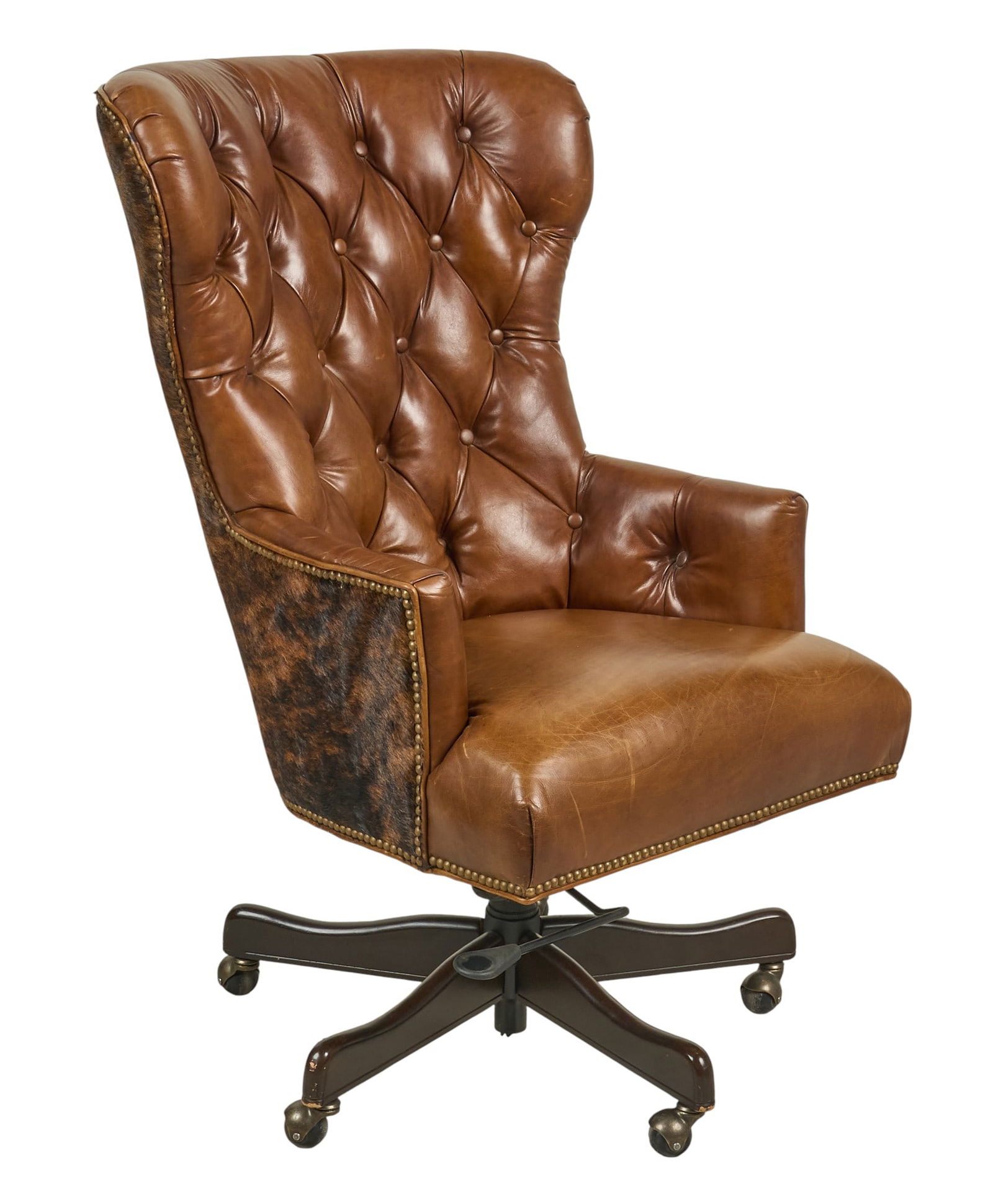 Ranch Style Office Chair: Ranch style office chair with tufted brown leather, and hair on hide upholstery, on swivel base height 45 in. x width 29 in. x depth 33 in. Provenance: Property from a home in San Antonio, Texas