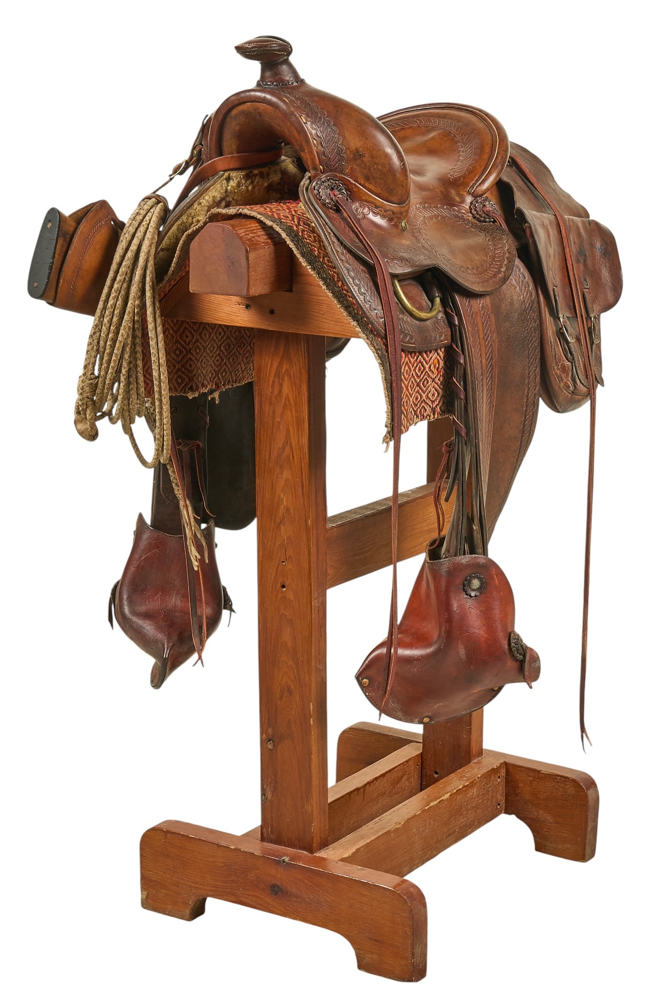 S. D. Myres Saddle with Stand: S. D. Myres saddle with Navajo saddle blanket, rawhide lariat, rifle scabbard, and saddle bags, dating from approximately the 1940s height 51 in. x width 32 in. x depth 30 in. Provenance: Propert