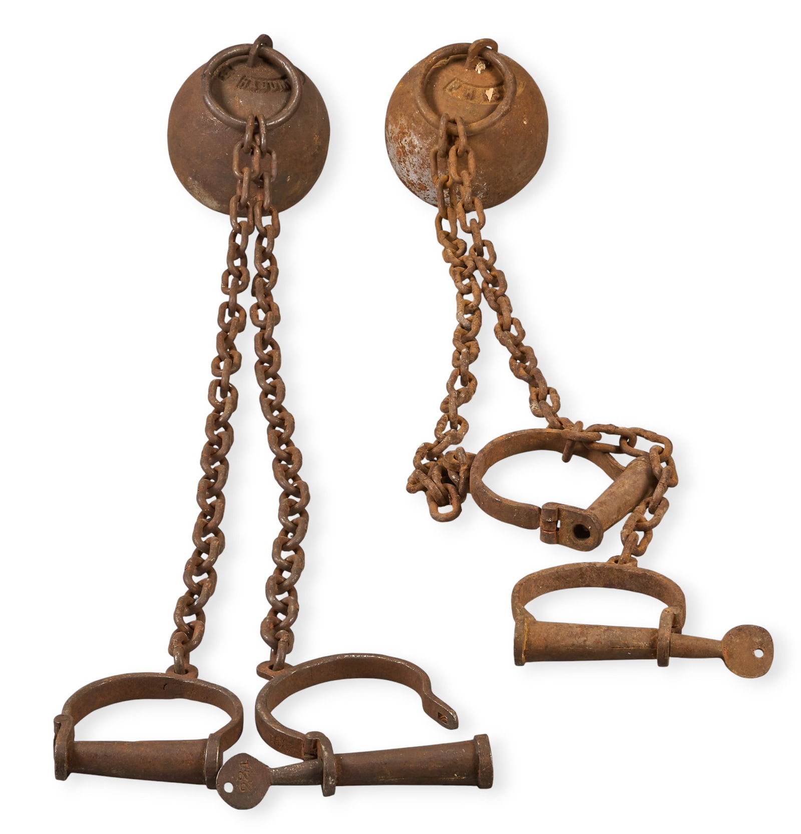 (2) Ball and Chain Prison Shackles: Two iron ball and chain prison shackles, with one from Alcatraz Prison and one from Leavenworth PrisonChain length: 39 in. / longestProvenance: Property from a home in San Antonio, Texas