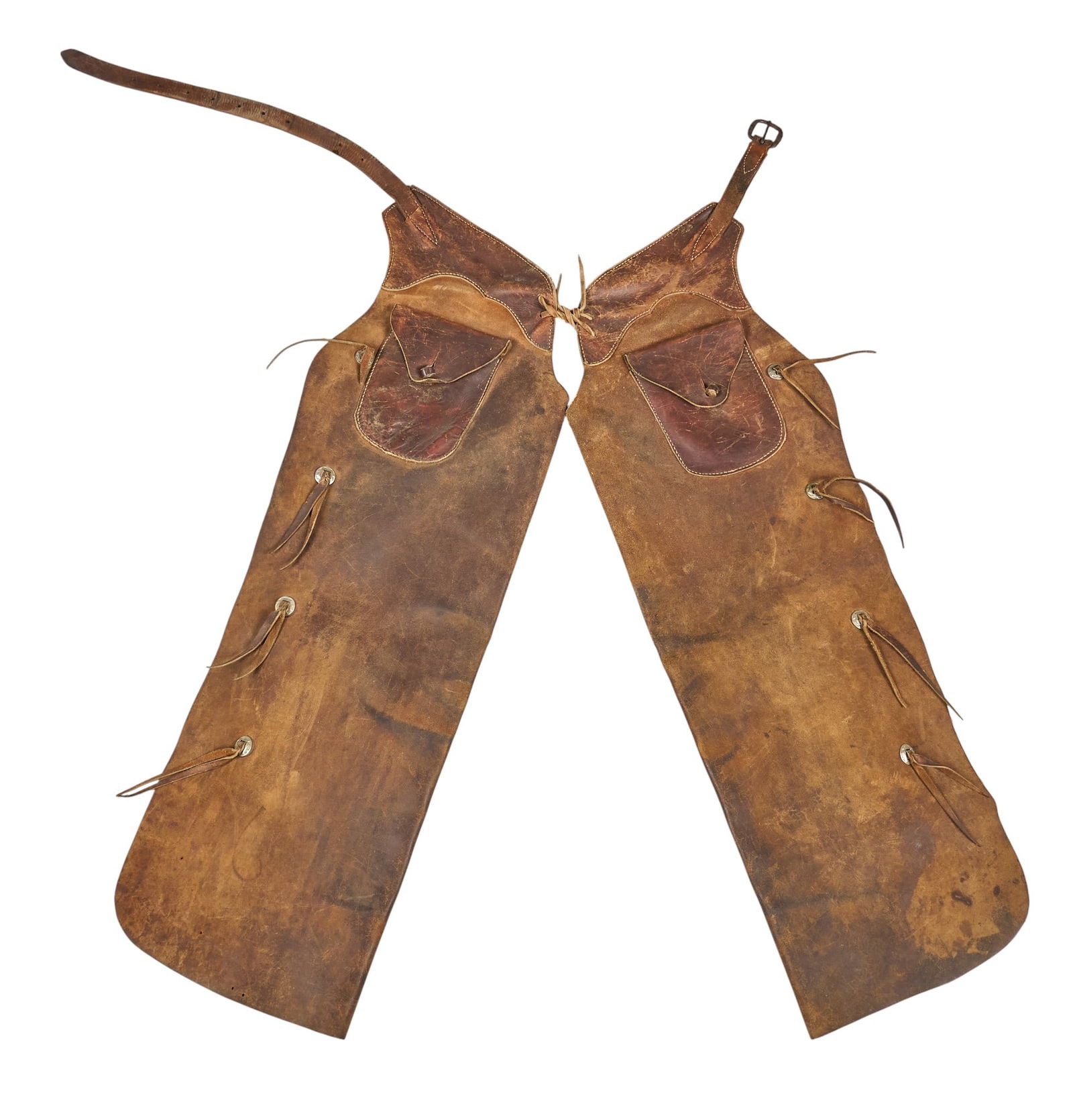 Vintage Leather Western Chaps: Pair of vintage leather working cowboy batwing chaps with pockets and adjustable straps, circa 1920s length 57 in. x width 47 in. Provenance: Property from a Boerne, Texas antiques collector
