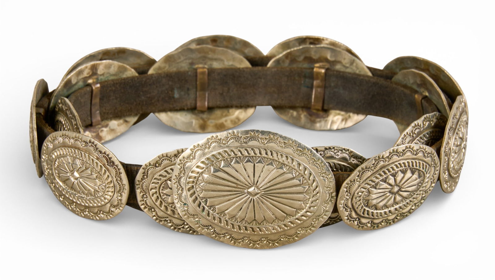 Sterling Silver Oval Concho Belt: Sterling silver oval-shaped concho belt, with sixteen conchos and buckle on brown leather belt Length: 33 in.Total weight: 7.94 ozt