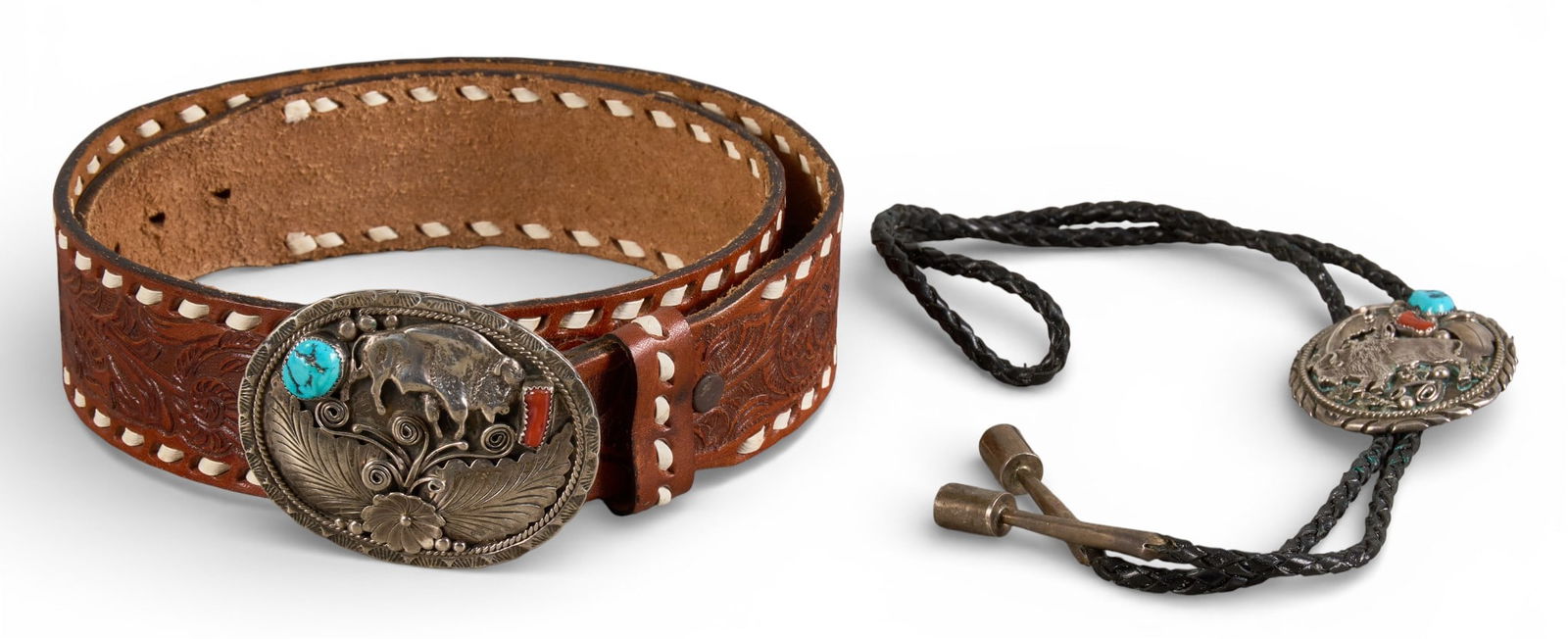 Sterling Silver, Turquoise, and Coral Bolo Tie & Belt Set: Bolo tie and belt set to include a bolo tie with sterling silver pendant featuring buffalo and feather motifs, and turquoise and coral inlay, and a tooled brown leather belt with sterling si