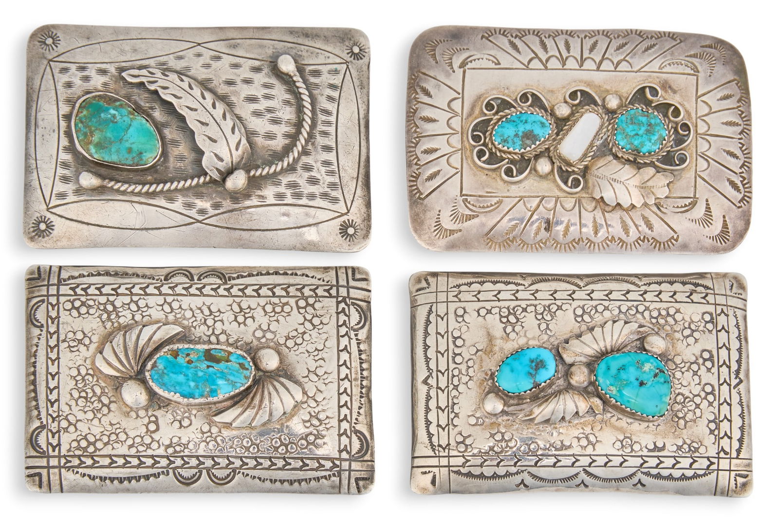 (4) Sterling & Turquoise Buckles: Group of four sterling silver Navajo belt buckles, each featuring inlaid turquoise, each signed to reverse Total weight: 5.515 ozt Provenance: Property from a home in San Antonio, Texas