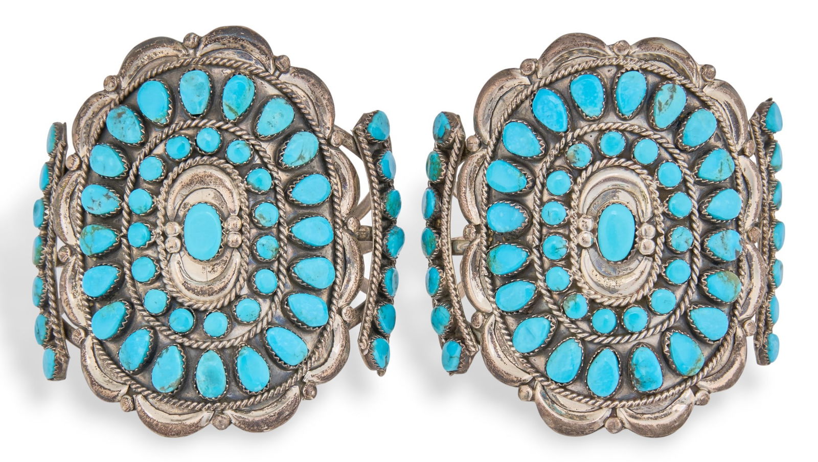 V.M. Begay, Pair of Turquoise Cluster Cuffs: Victor Moses Begay, pair of sterling silver cuff bracelets, with inlaid turquoise cluster design, each signed "VMB"Circumference: 6.75 in. / each Total weight: 4.4 oztProvenance: