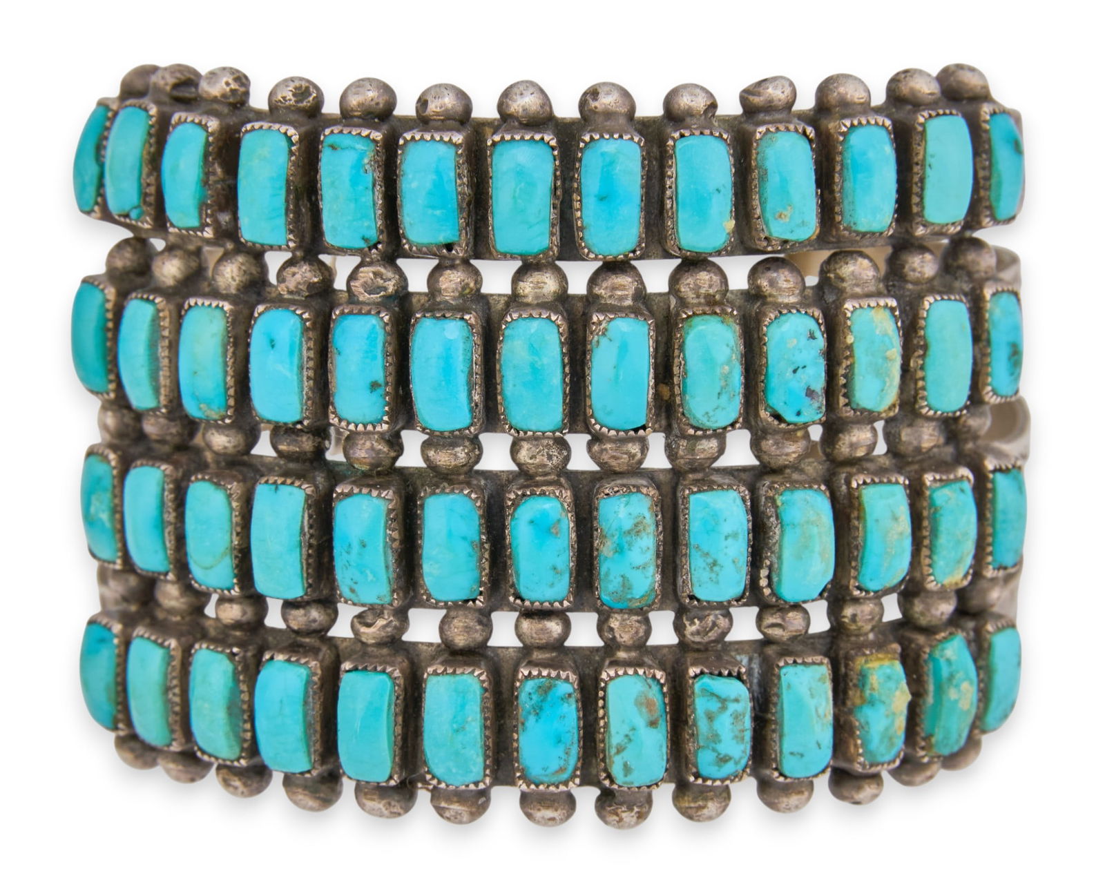 Zuni Four-Row Sterling & Turquoise Cuff: Zuni sterling silver cuff bracelet, with four rows of inlaid turquoise cabochons, possibly by Carrie Katsineh Circumference: 6.75 in.Total weight: 2.755 ozt