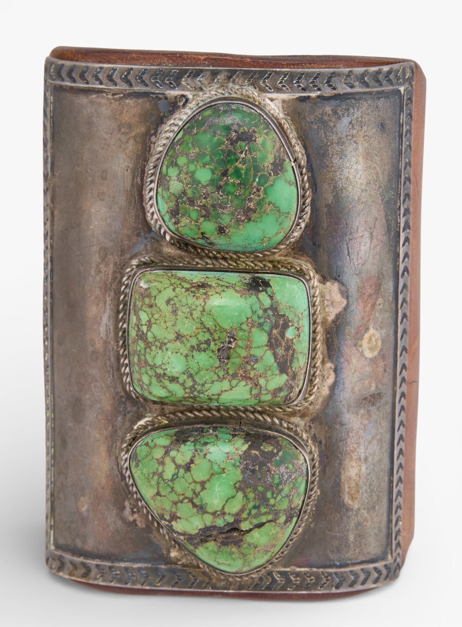 Early Navajo Turquoise Ketoh: Large early Navajo ketoh, with inlaid turquoise stones and twisted rope details, on brown leather band, circa 1920s/30sTotal weight: 6.335 oztProvenance: Property from a home in San Antonio, Texas