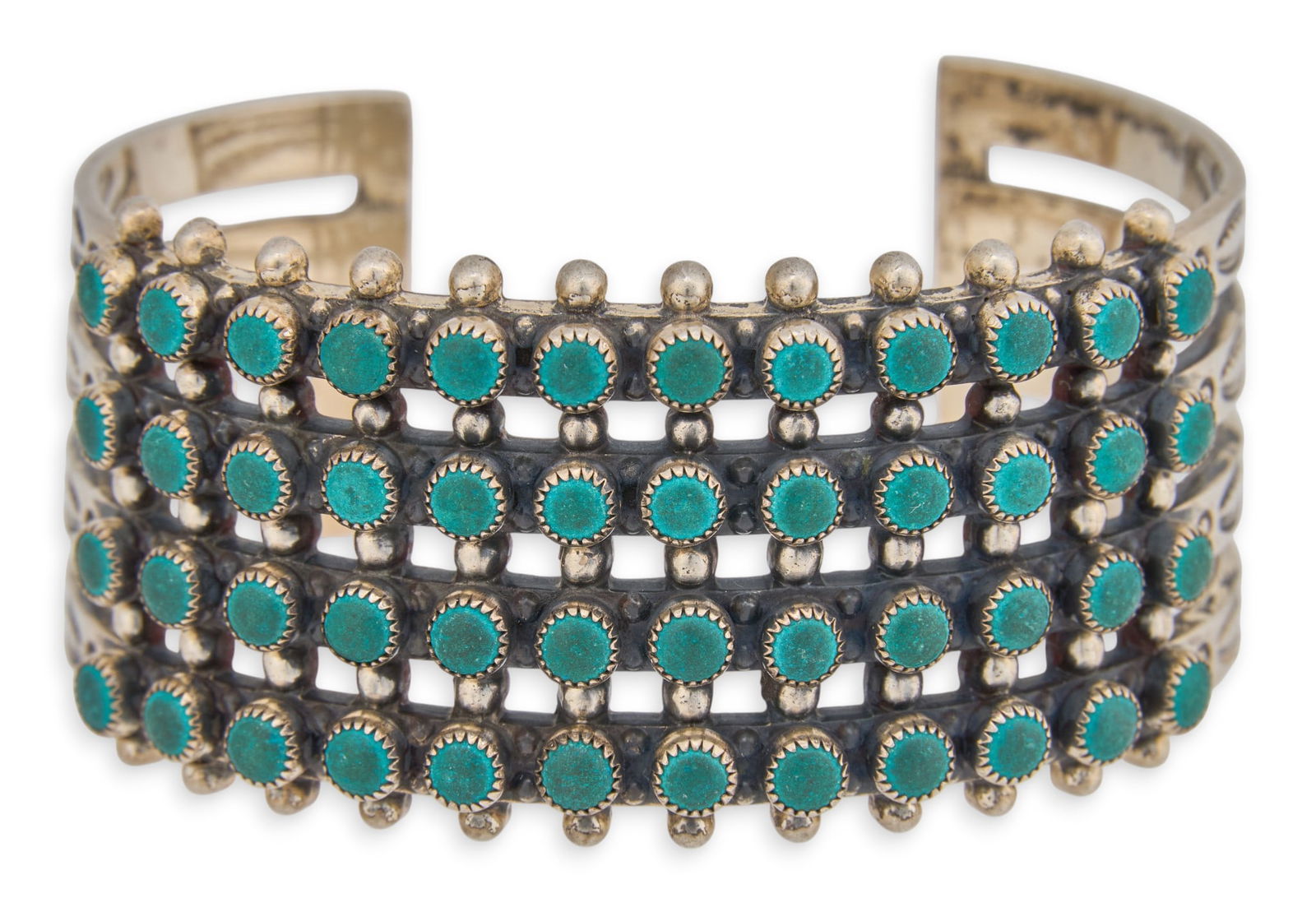 Zuni Turquoise Petit Point Cuff Bracelet: Zuni sterling silver cuff bracelet with four rows of inlaid petit point turquoise stones, marked "Sterling" Circumference: 6.5 in.Total weight: 1.835 ozt