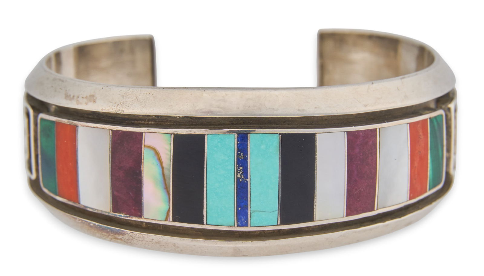 Signed "HSB" Inlay: Navajo sterling silver cuff bracelet with inlaid stones in geometric design, marked "Navajo H.S.B. Sterling"Circumference: 6.5 in. Total weight: 1.835 oztProvenance: Property from the