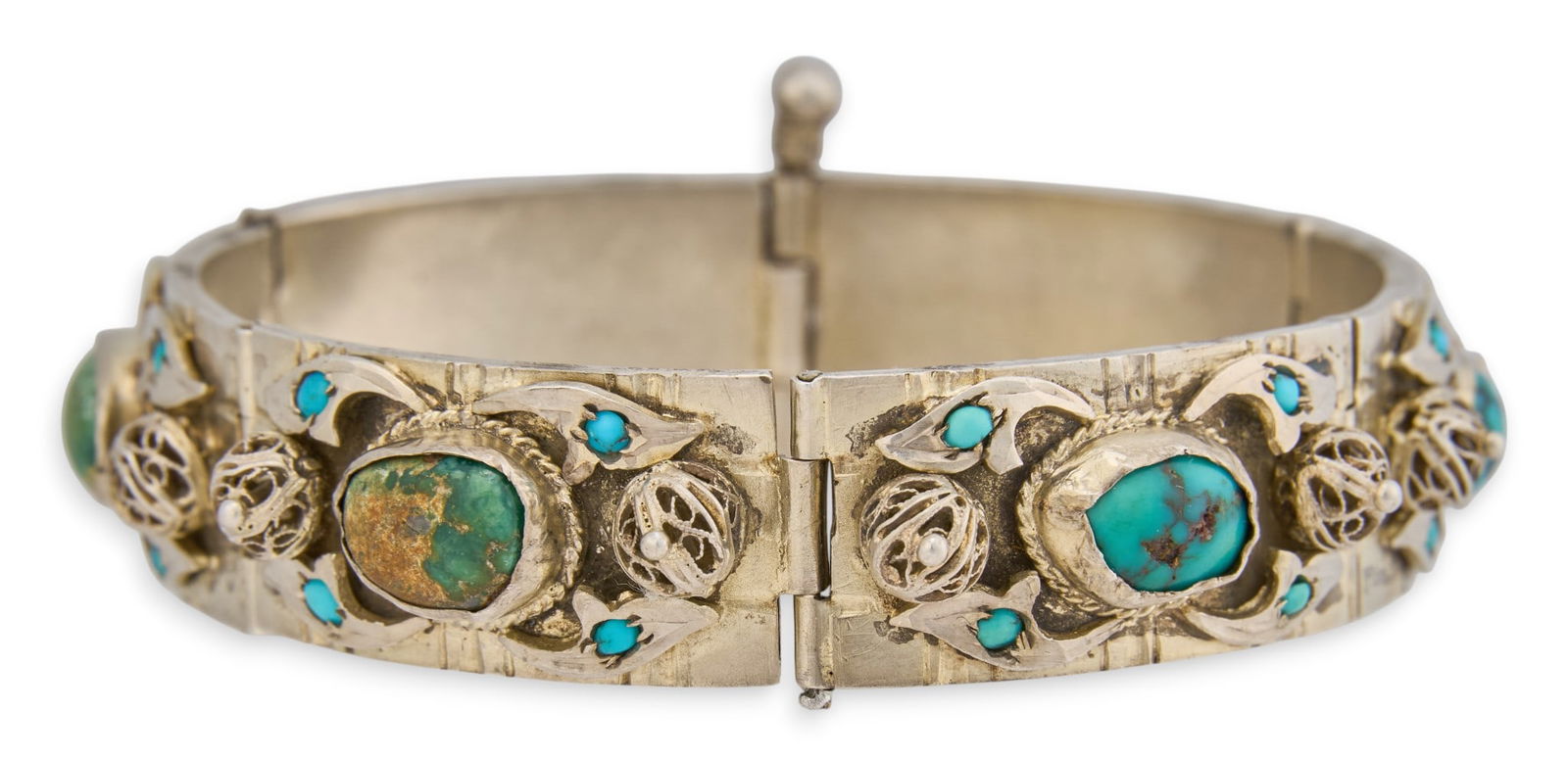 Hinged Sterling & Turquoise Bracelet: Hinged sterling silver bracelet with inlaid turquoise stones and filagree details, with hinged pin closureLength: 7.5 in. Total weight: 1.41 oztProvenance: Property from the collection of a