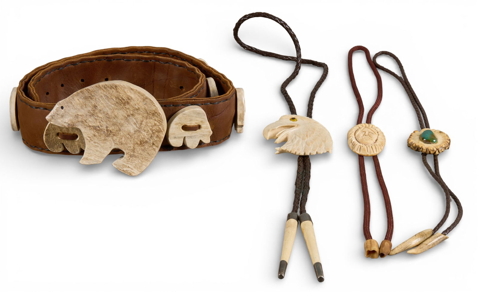 (4) Native American Bone & Antler Jewelry: Collection of Native American jewelry to include two bolo ties with pendants made from carved bone, depicting eagle and man's head, a carved antler bolo tie with inlaid turquoise, and a brown leat