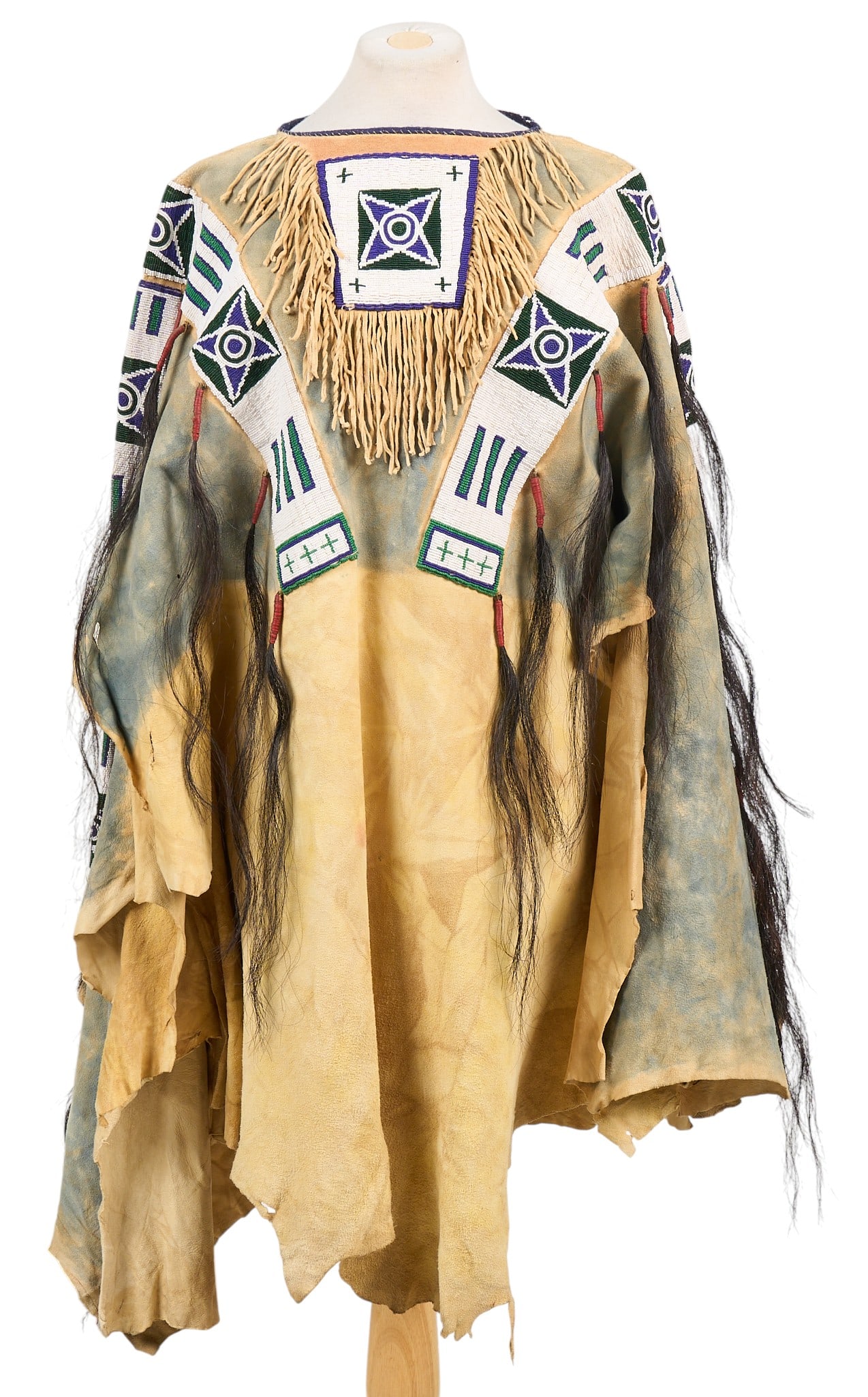 Buckskin War Shirt: Handcrafted replica Native American war shirt, tanned hide, horsehair, other natural materialsheight 39 in. x width 38 in.Provenance: Property from a Boerne, Texas antiques collector