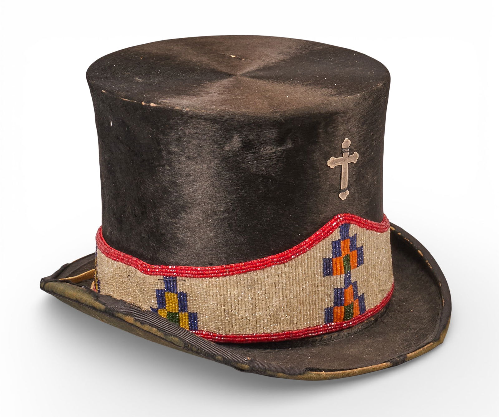 Native American Style Beaver Hat: Native American style beaver top Hat with early glass beaded headband with brain tanned ties and an early hammered crossheight 6.5 in. x width 9.5 in. x depth 12 in. Provenance: Property from