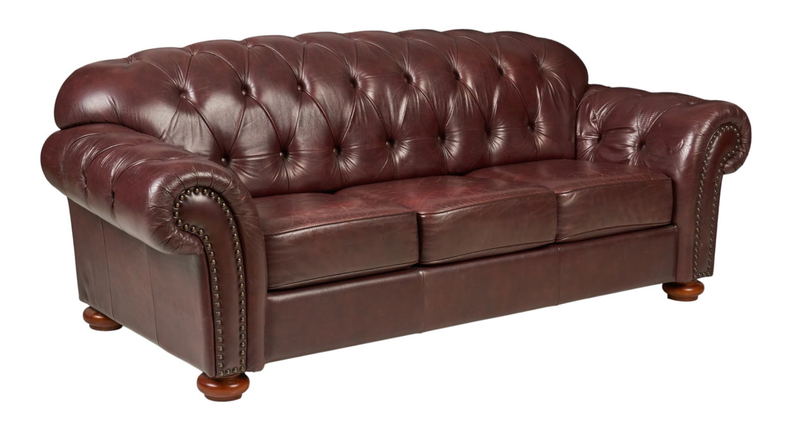 Tufted Leather Sofa: Sofa with tufted reddish-brown leathe rupholstery, supported on bun feet height 35 in. x width 88 in. x depth 35 in. 