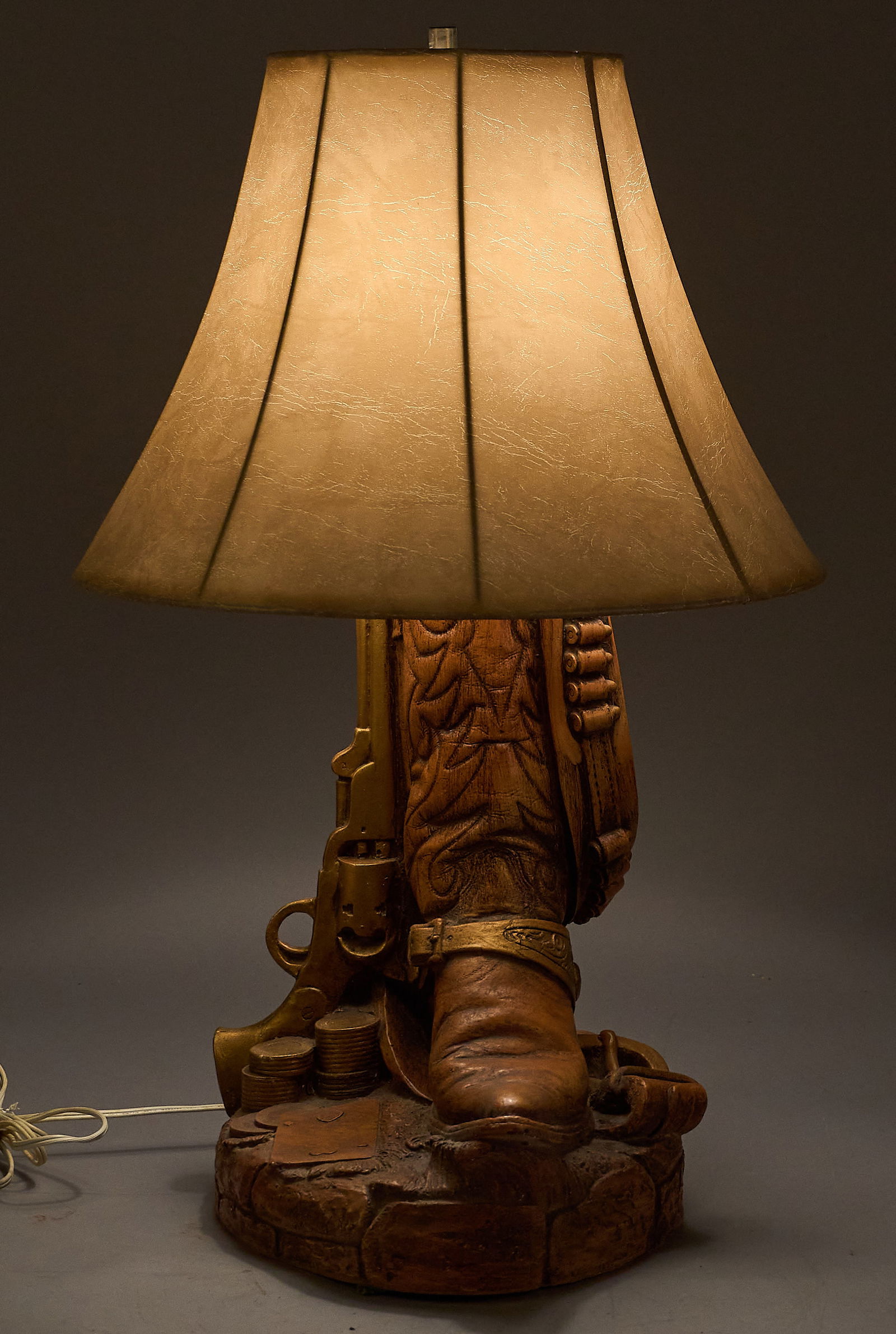 Ranch Style Table Lamp: Ranch style table lamp with Western cowboy boot and pistol motifheight 27 in. x width 17 in. x depth 17 in. Provenance: Property from a home in San Antonio, Texas 