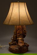 Ranch Style Table Lamp: Ranch style table lamp with Western cowboy boot and pistol motifheight 27 in. x width 17 in. x depth 17 in. Provenance: Property from a home in San Antonio, Texas