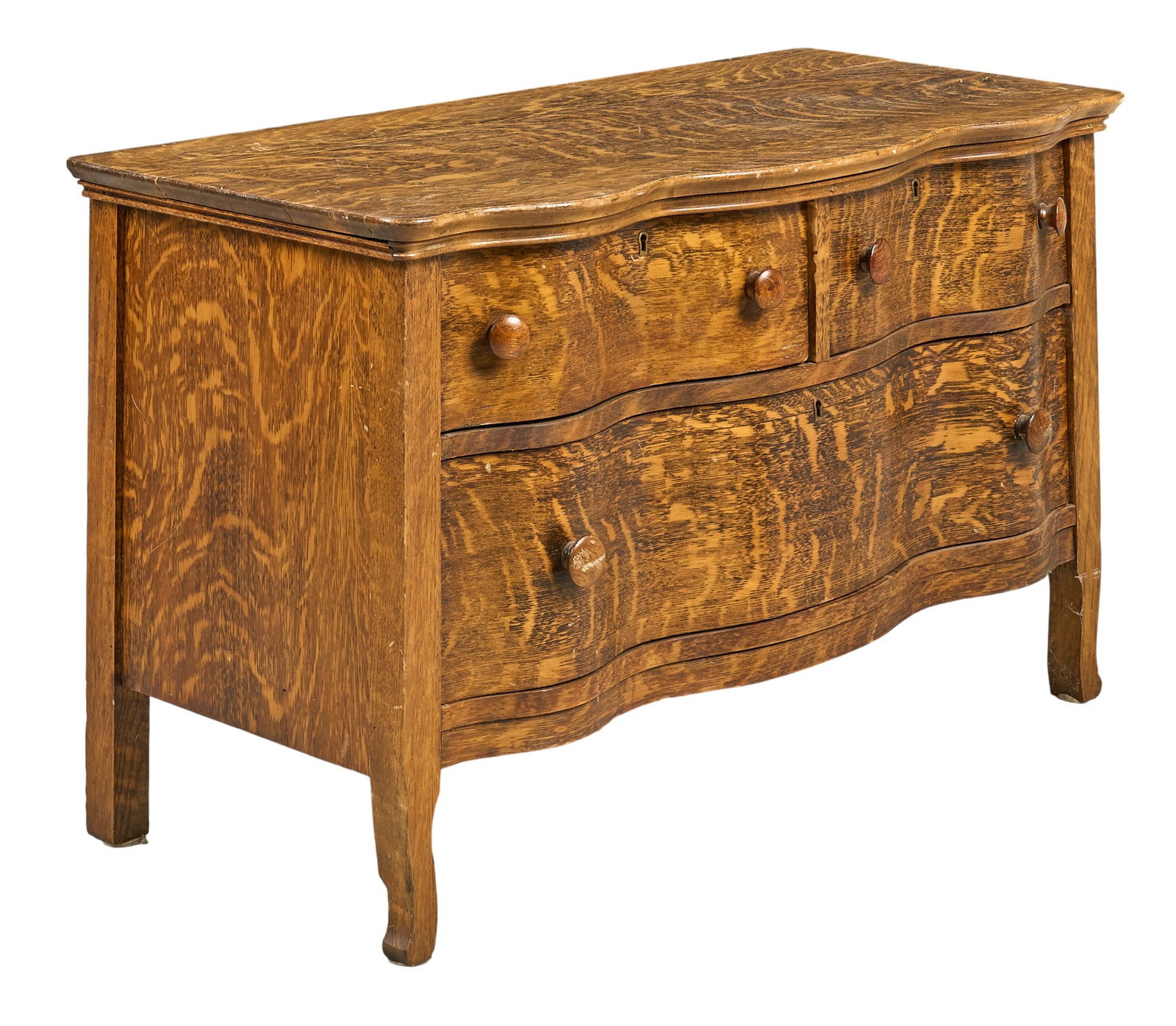 Low Chest of Drawers: Rustic low chest of three drawers with serpentine front, supported on block legsheight 25 in. x width 42 in. x depth 20.5 in. 
