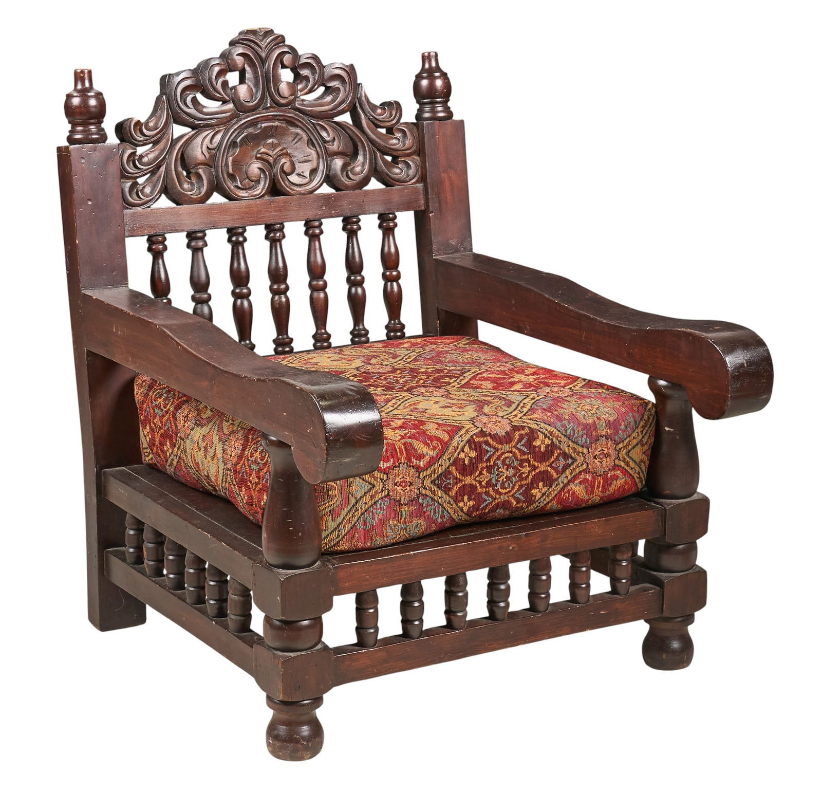 Carved Wood Hacienda Armchair: Spanish armchair featuring carved wood frame, spindle back, scrolled arms, and removable upholstered cushionheight 39 in. x width 30.5 in. x depth 37 in.Provenance: Property from a home in San