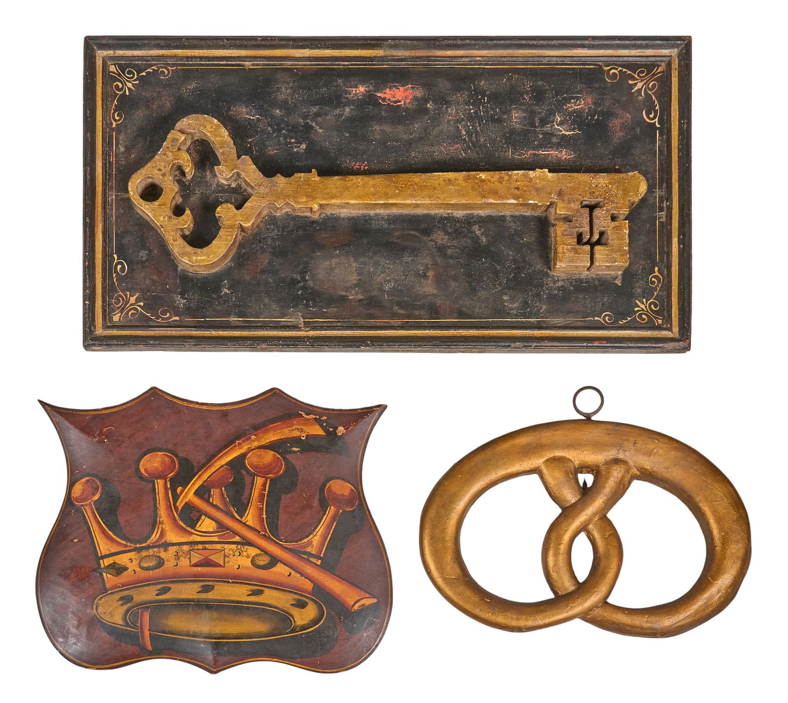 Group of Three Painted Trade Signs: Three vintage painted trade signs, with one key, a crown with tools on a shield, and a pretzelheight 18.5 in. x width 36 in. x depth 2 in. / largestProvenance: Property from a home in San