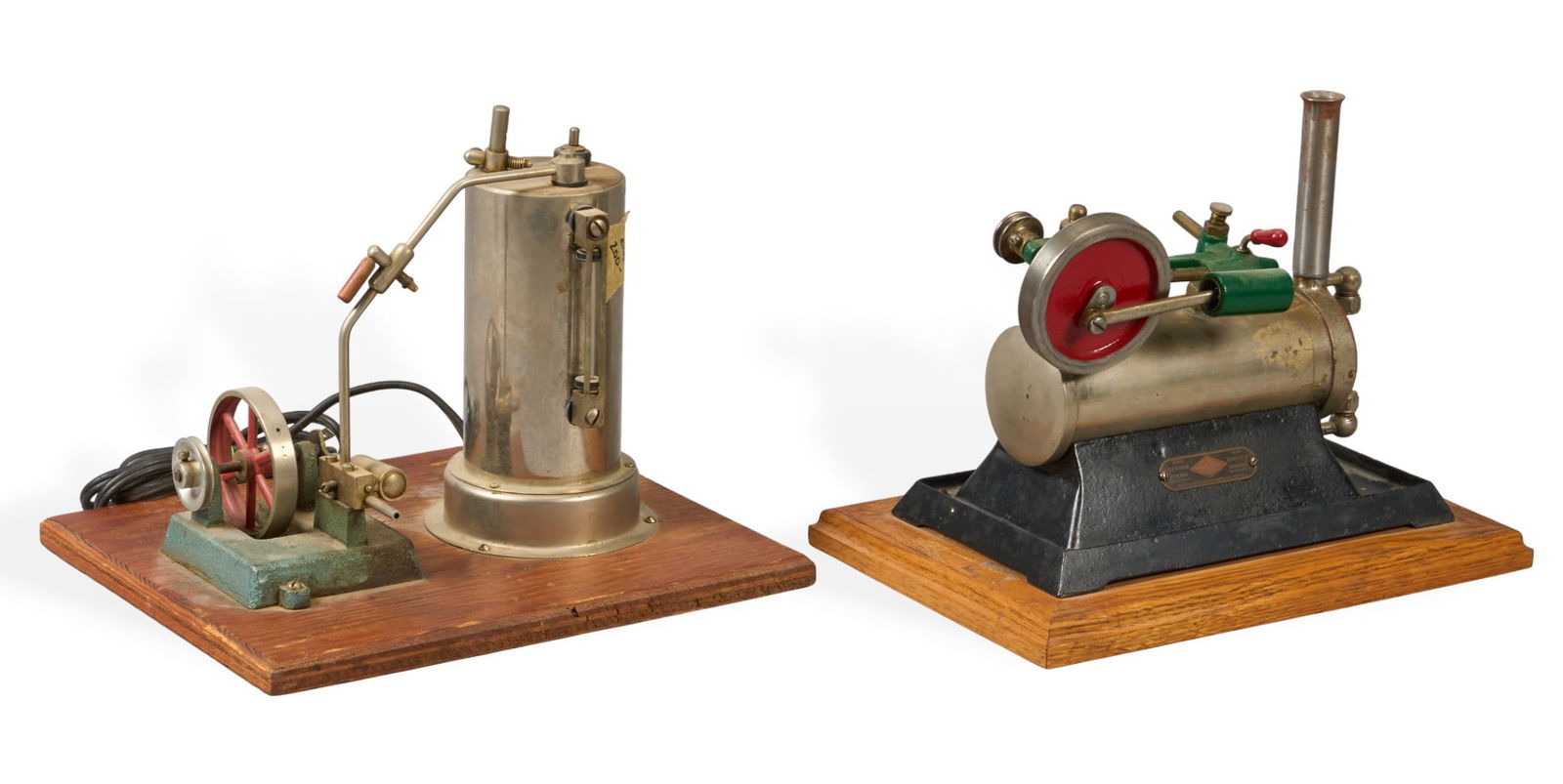 Pair of Jensen MFG. Co. Steam Engines: Two vintage Jensen MFG. Co. steam engines, each mounted on a wooden base, with one vertical boiler type, and one horizontal type with a red flywheelheight 9 in. x width 11.5 in. x depth 9.5 in.