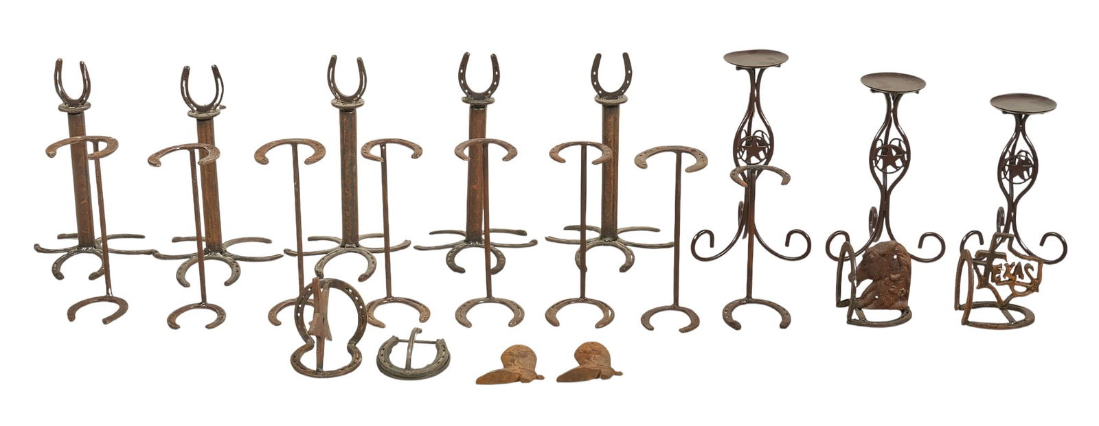 Collection of Western Iron Decor: Collection of decorative iron decor including horseshoe stands, candle holders, and boot-shaped wall hangings\height 16 in. x width 10.5 in. x depth 9.5 in. / largest Provenance: Property from a