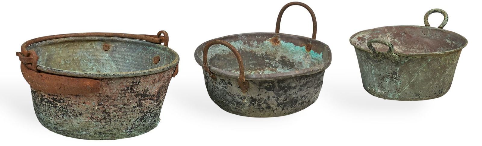 (3) Vintage Copper Cauldrons: Three vintage copper cauldrons with dark patina, and iron handles height 10 in. x width 16 in. x depth 17 in. / largest Provenance: Property from a home in San Antonio, Texas