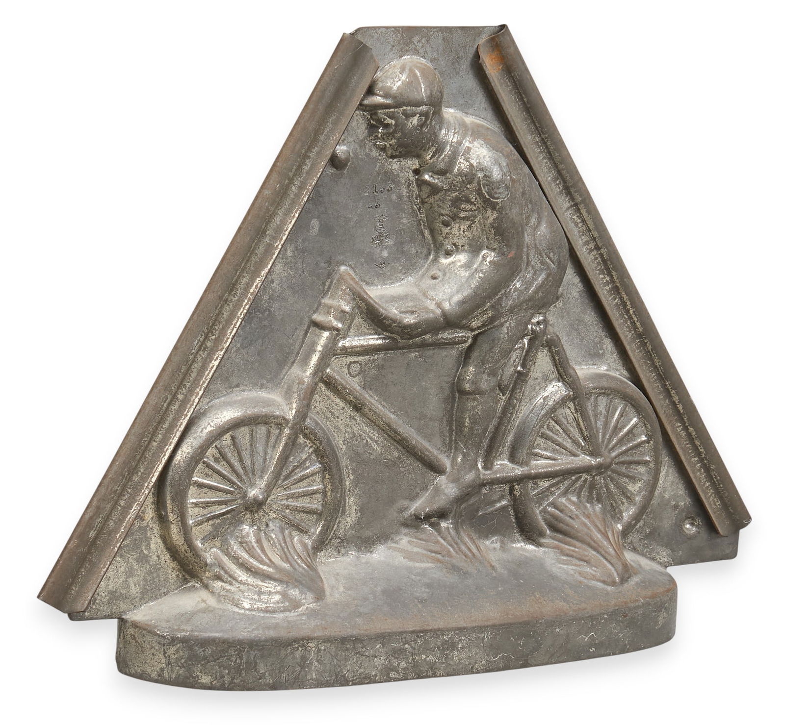 Antique Man on Bicycle Chocolate Mold: Antique chocolate mold depicting a man riding a bicycleheight 8.5 in. x width 11 in. x depth 3.5 in. Dimensions: 8.5 x 11 x 3.5 inches.