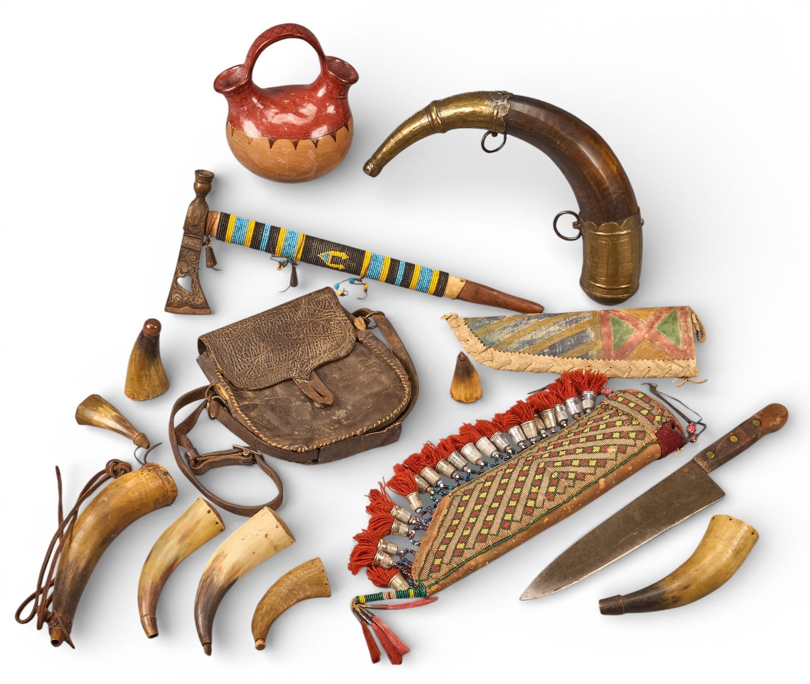 Collection of Western Americana Items: Collection of Western Americana items to include nine powder horns, tomahawk, western leather satchel, two Southwestern knife sheaths, and a Maricopa pottery vesselheight 16 in. x