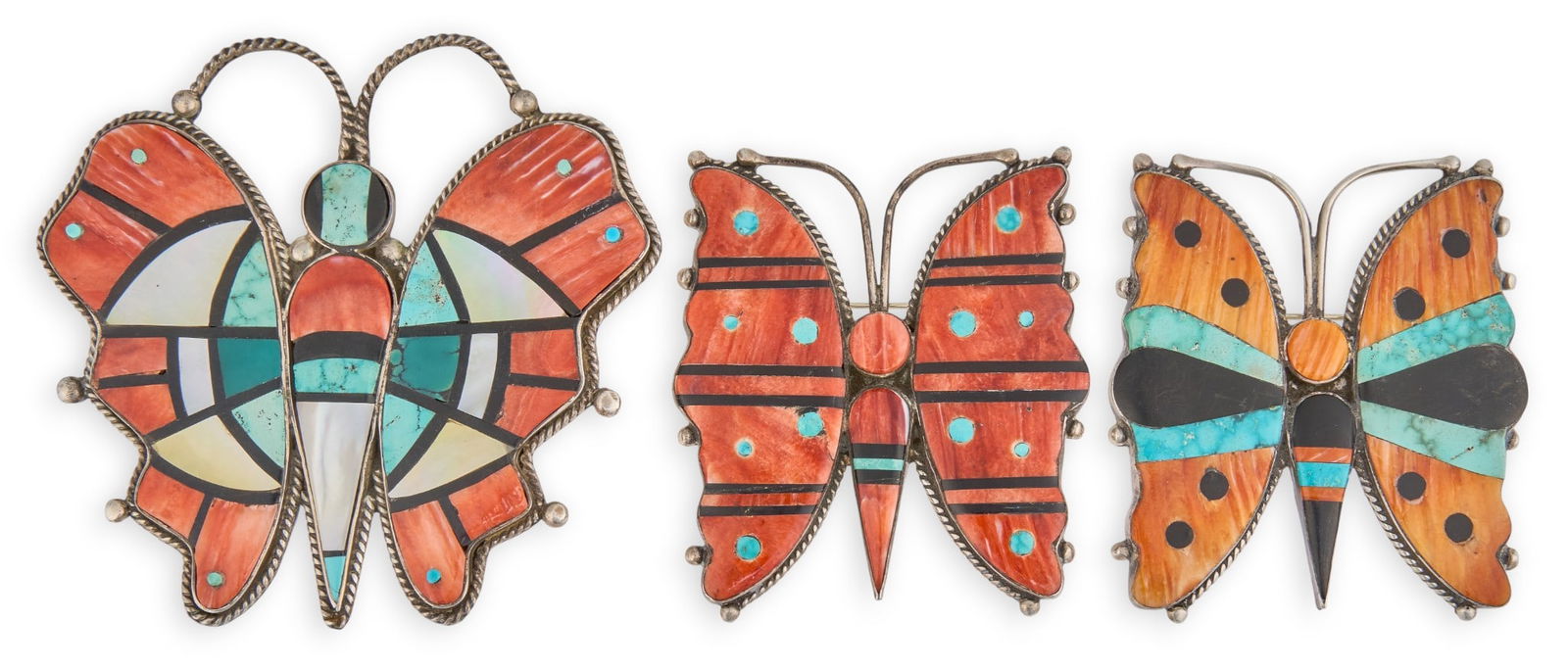 (3) Zuni Sterling & Stone Inlay Butterfly Pendants: Three Zuni sterling silver and multi-stone inlay butterfly pins, one with pendant loop, featuring turquoise, coral, shell, and onyx, with twisted rope details, marked "Sterling"Size: 3.25
