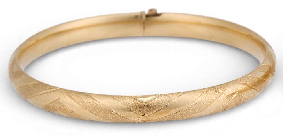 14K Hinged Cuff: 14K yellow gold hinged cuff, with textured finish, marked "R&D 14K" Circumference: 7 in.Total weight: 7.6 g Prov