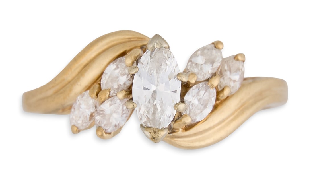 14K Marquise Diamond Ring: 14K yellow gold marquise diamond ring, with central diamond flanked by six smaller marquise-cut diamonds, marked "14K"Size: 8.5 Total weight: 3.5 gProvenance: Property from a home in