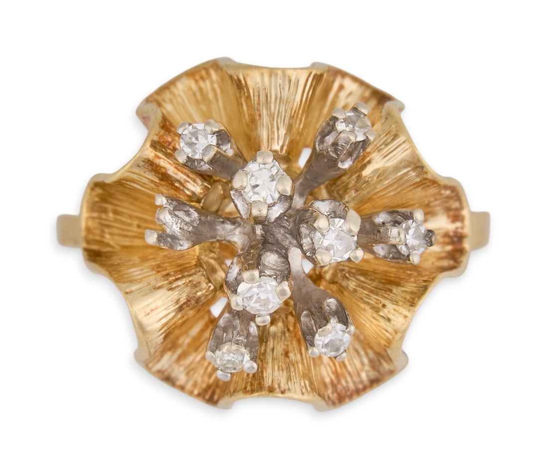 14K Diamond Cocktail Ring: 14K yellow gold diamond floral ring, featuring a sculptural, openwork flower-form head with textured gold petals, centering a cluster of round brilliant and tapered baguette-cut diamonds arranged in