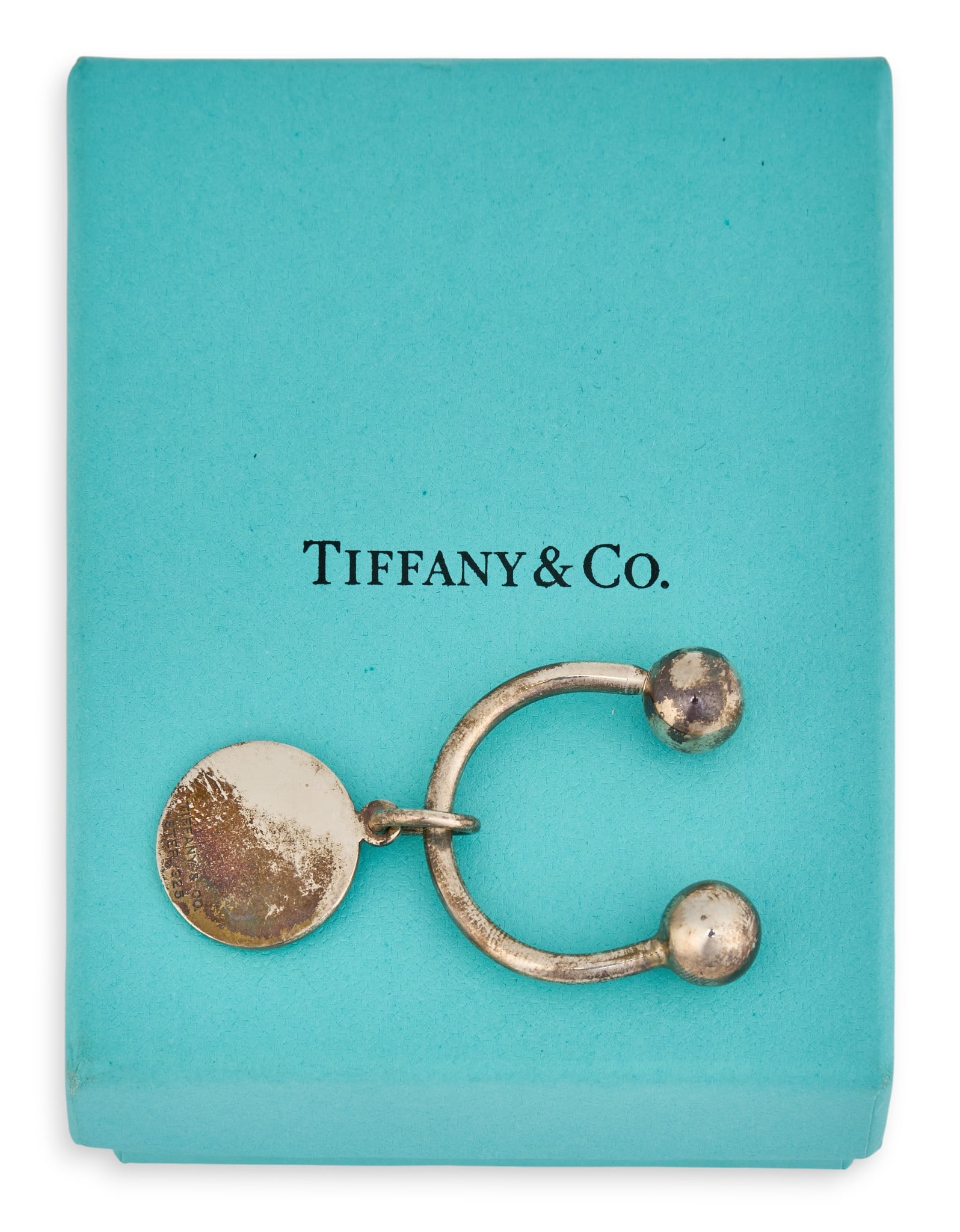 Tiffany & Co. Sterling Silver Key Ring: Tiffany & Co. sterling silver key ring with charm, marked "Tiffany & Co. Sterling 925"Total weight: 0.32 oztProvenance: Property from a home in San Antonio, Texas