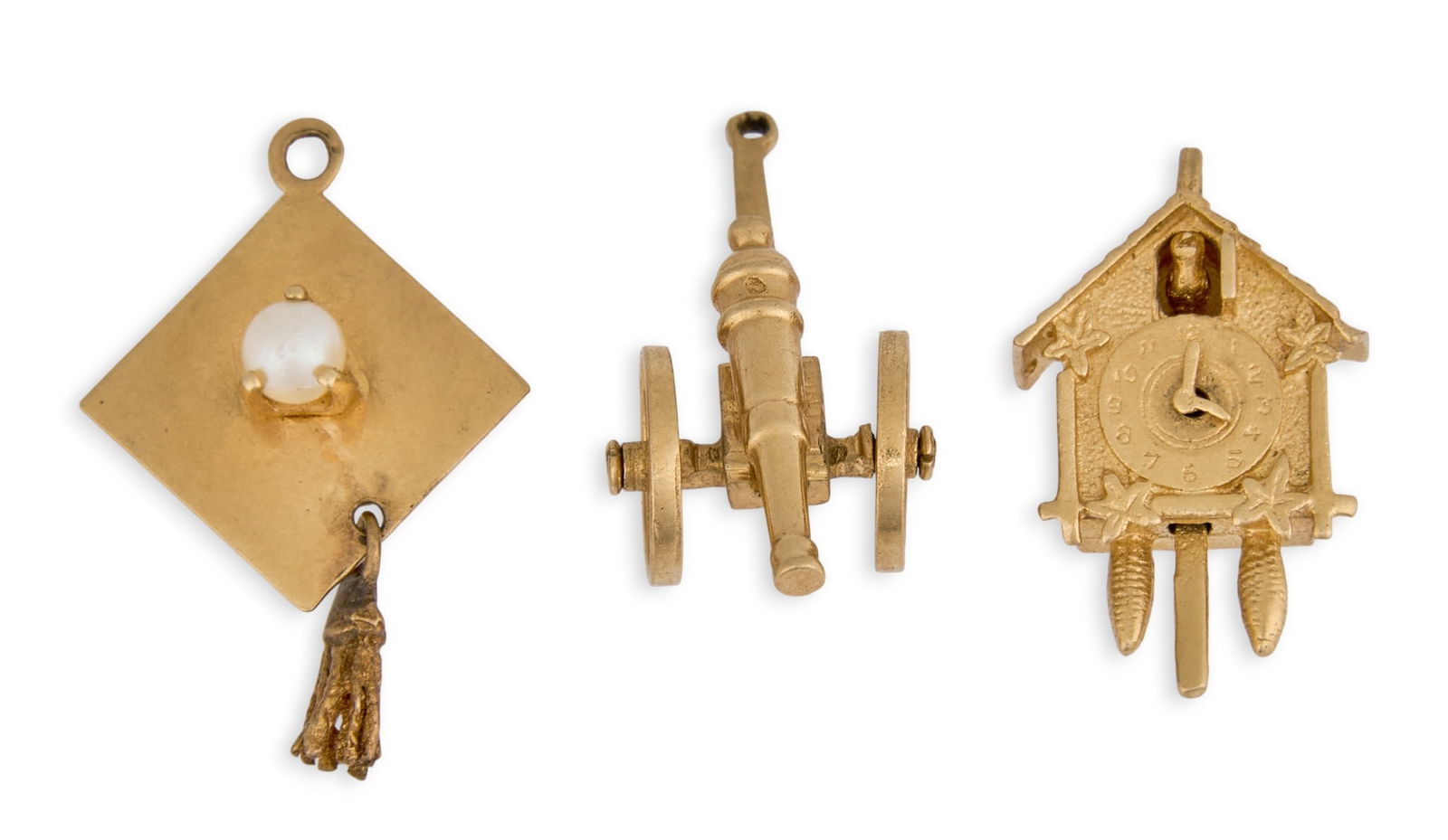 (3) 14K Gold Charms: Three 14K yellow gold charms, depicting a cuckoo clock, cannon, and graduation cap, marked "14K"Total weight: 7.7 g