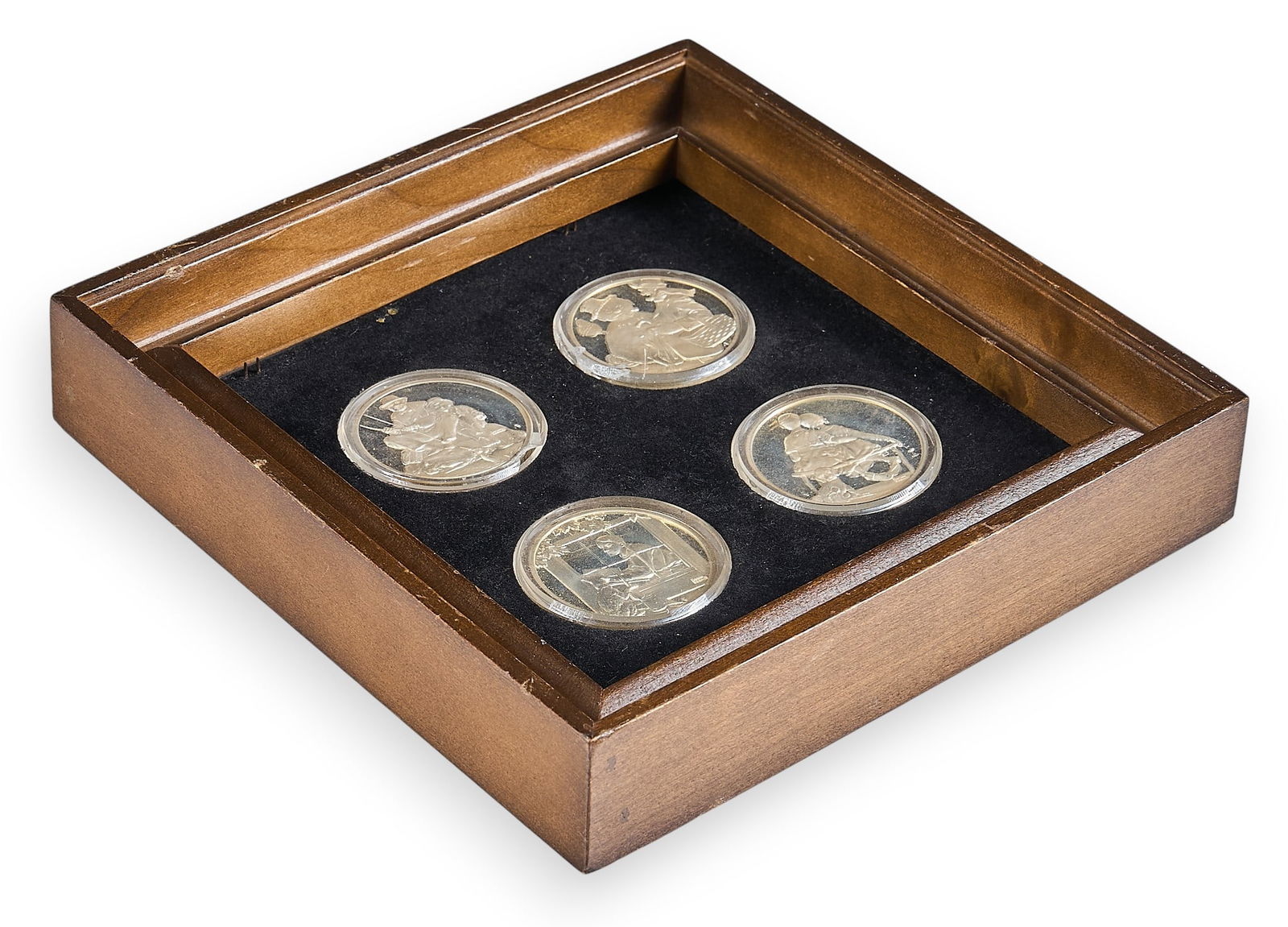 (4) Framed "The Four Seasons" Silver Coins: The Hamilton Mint's "The Four Seasons" collection, housed in a wooden frame, with scenes from Norman Rockwell's "The Four Seasons" artwork Provenance: Property from a home