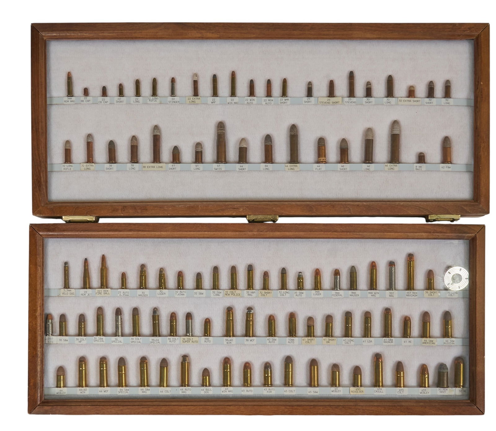(Pair) US Rimfire and US Handgun Cartridge Displays: Includes: cartridge displays in cases w/ labels on the reverse-US Rimfire Cartridge display: 38 cartridges from 5mm Rem Mag to 42 F&W-US Pistol Cartridge display: 62 cartridges from 5.5mm Velo Dog