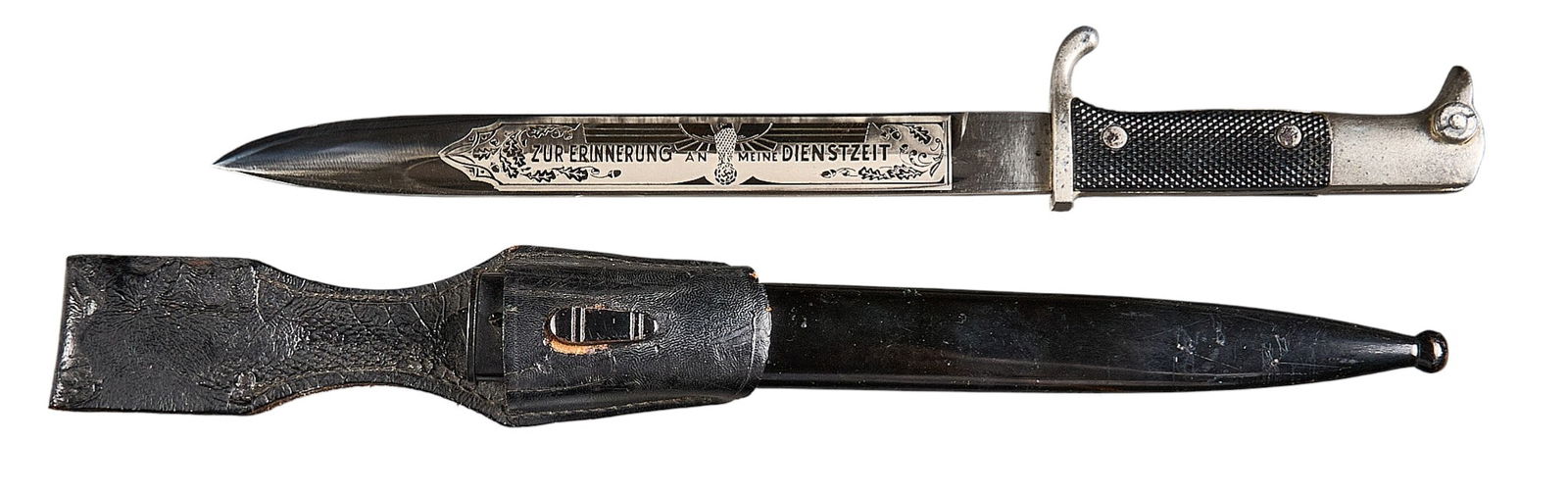 WWII German Etched Dress Bayonet w/ Scabbard: Manufacturer: Chr. Loewe-Hanau /M., GermanyModel: Dress bayonetBlade Length: 9.375 in.OAL: 14.125 in. (15.5 in. w/ scabbard)Condition: Good; blade has moderate wear from scabbard rubbing and 