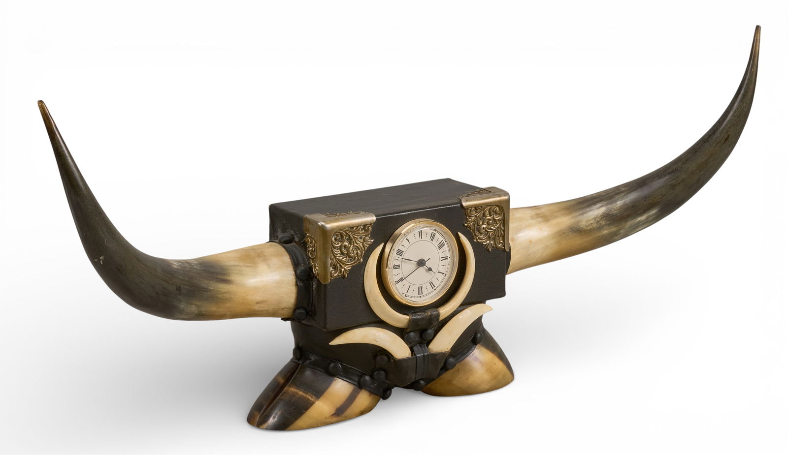 Steer Horn Desk Clock: Ranch style desk clock with steer horns, leather wrapping, and decorative metal accents, clock face framed by javelina teeth, supported on steer hoovesheight 12 in. x width 26 in. x depth 5.5