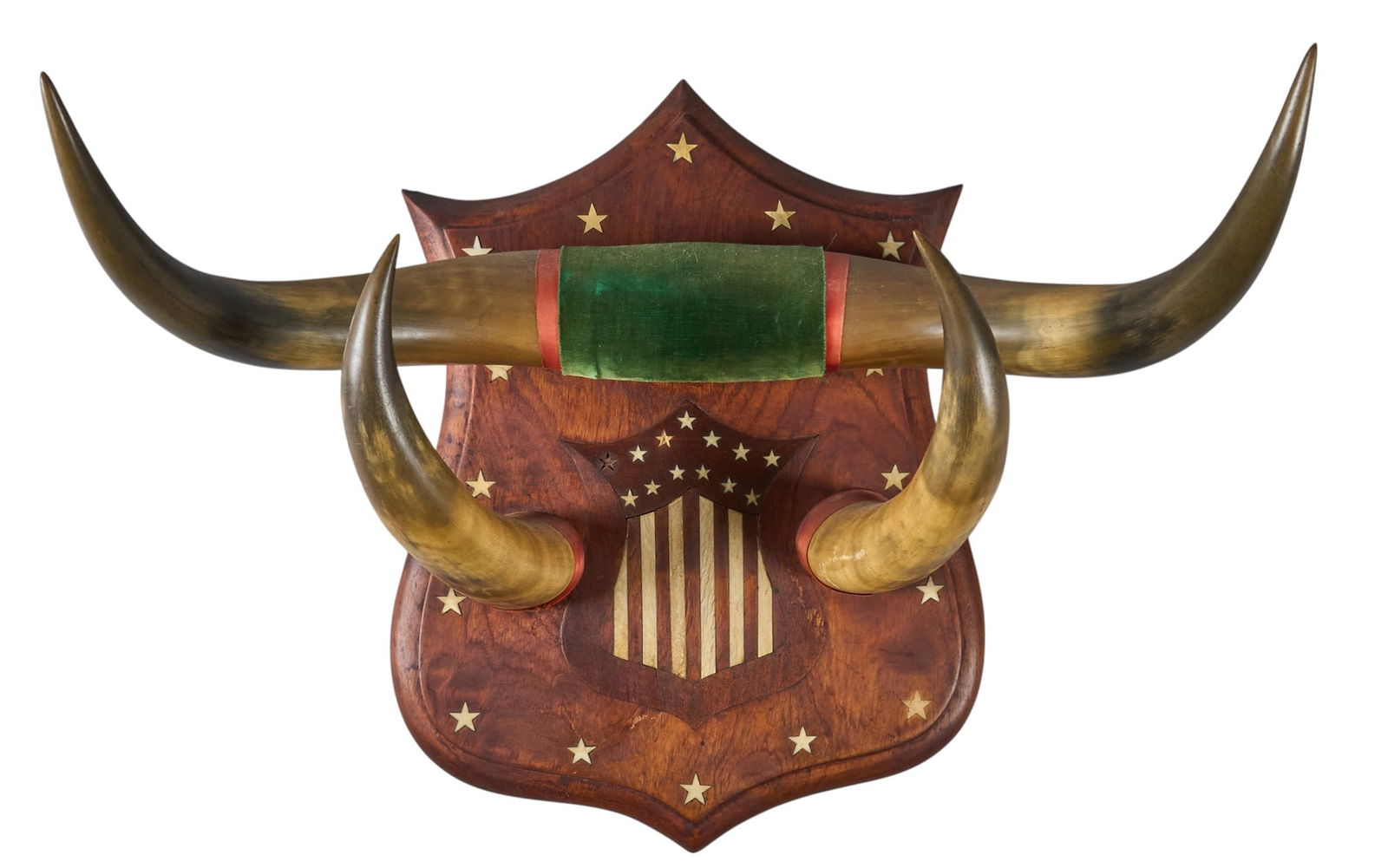 Mounted Horns on Inlaid Shield Panel: Mounted horns on a shield-shaped wood panel with inlaid stars and stripesheight 19 in. x width 21 in. x depth 13 in. Provenance: Property from a Bandera, Texas art and antiques collector 