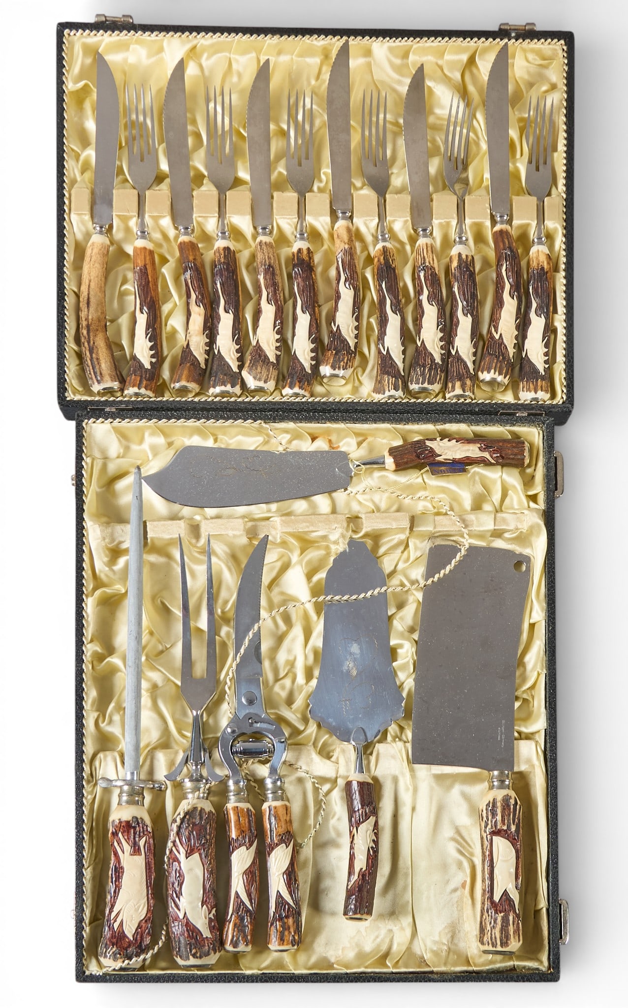 (2) Sets of Antler Handled Cutlery: Two sets of antler-handled cutlery, in satin-lined cases, to include knives, forks, and various serving utensilsProvenance: Property from the personal collection of a long-time Alamo Heights,
