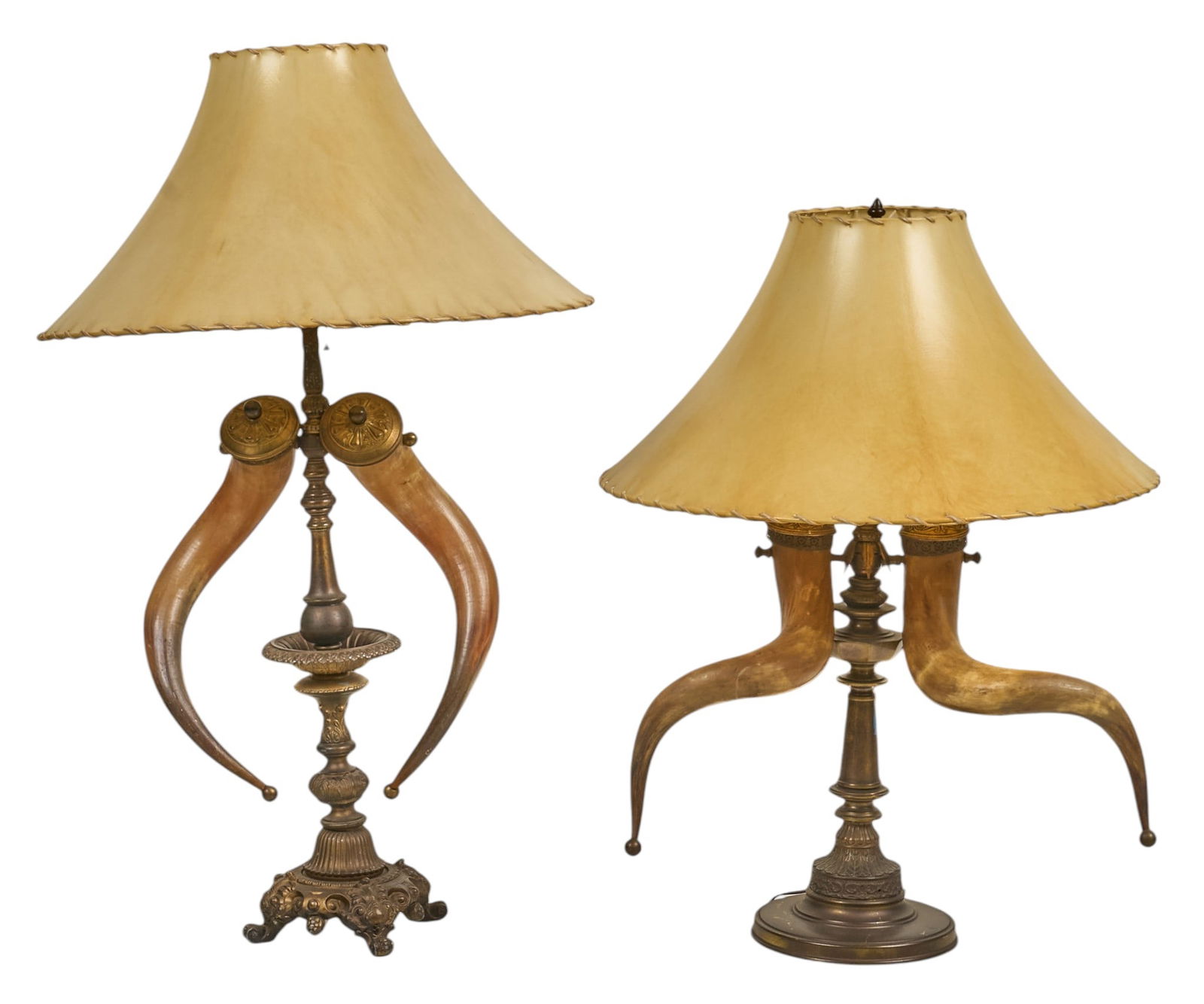 Pair of Powder Horn Table Lamps: Pair of table lamps, each with two powder horns mounted on ornate metal bases and topped with leather shadesheight 43 in. x width 18 in. x depth 10 in. / largestProvenance: From the estate