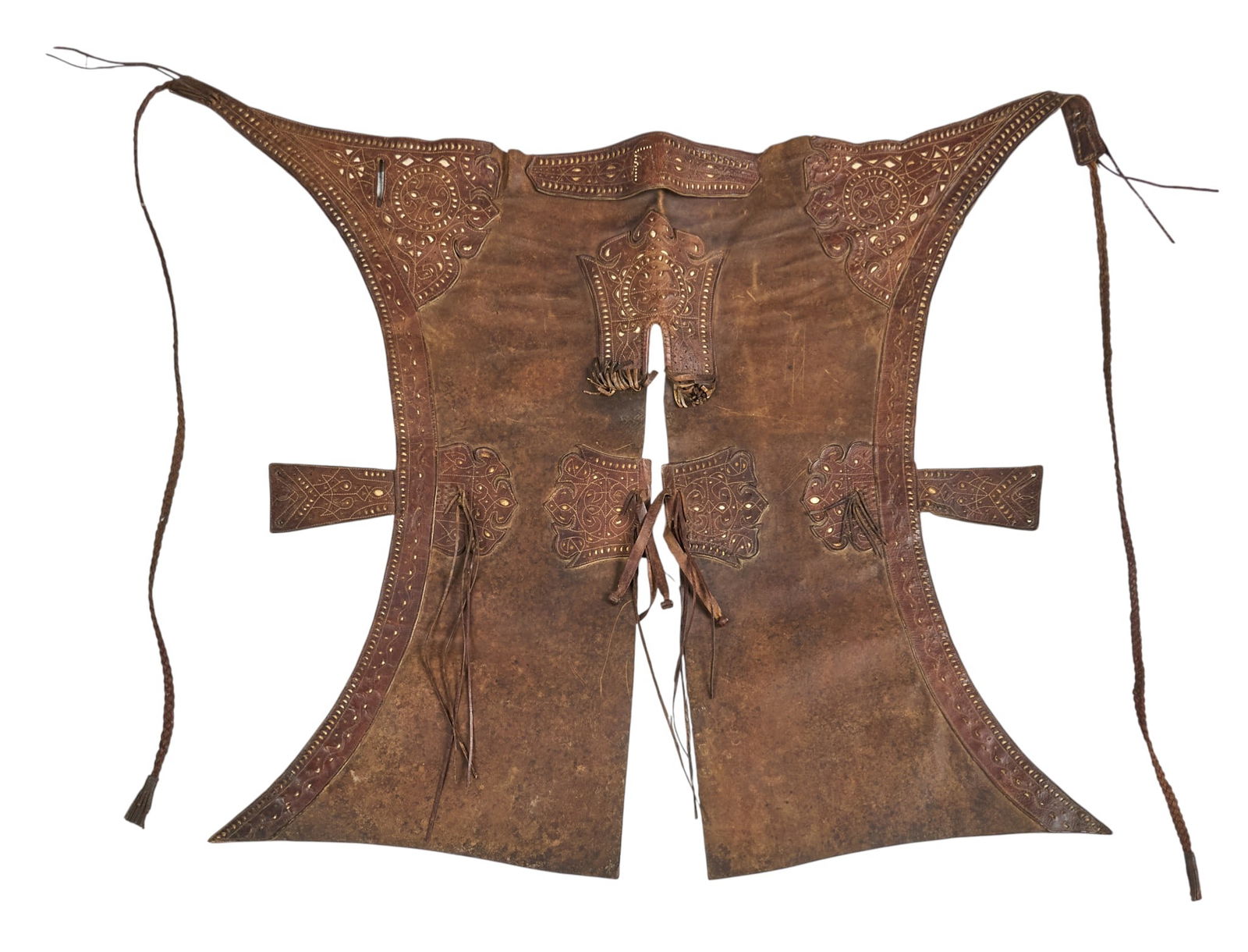Pair of Early Mexican Chaps: Pair of early Mexican leather riding chaps with lace-like cut-out designs in leather, and braided strapslength 39 in. x width 52 in. Provenance: Property from a San Antonio, Texas collector of