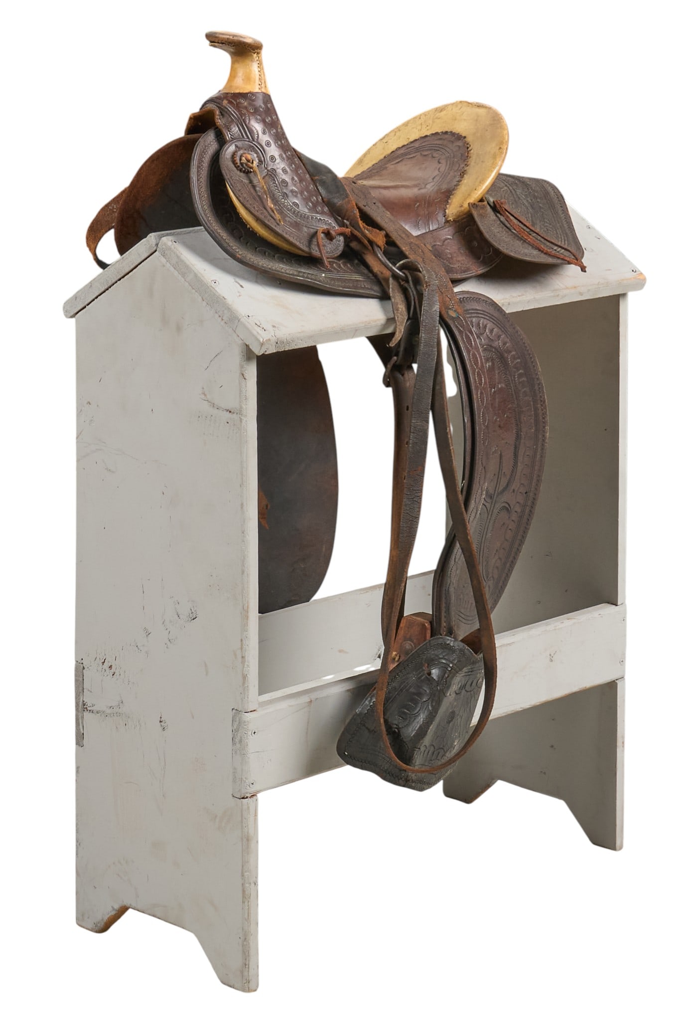 Primitive Child's Saddle: Primitive child's saddle with stirrups, and tooled leather, stand not included height 33 in. x width 16 in. x depth 23 in. Provenance: Property from the estate of a prominent San Antonio, Texas bu