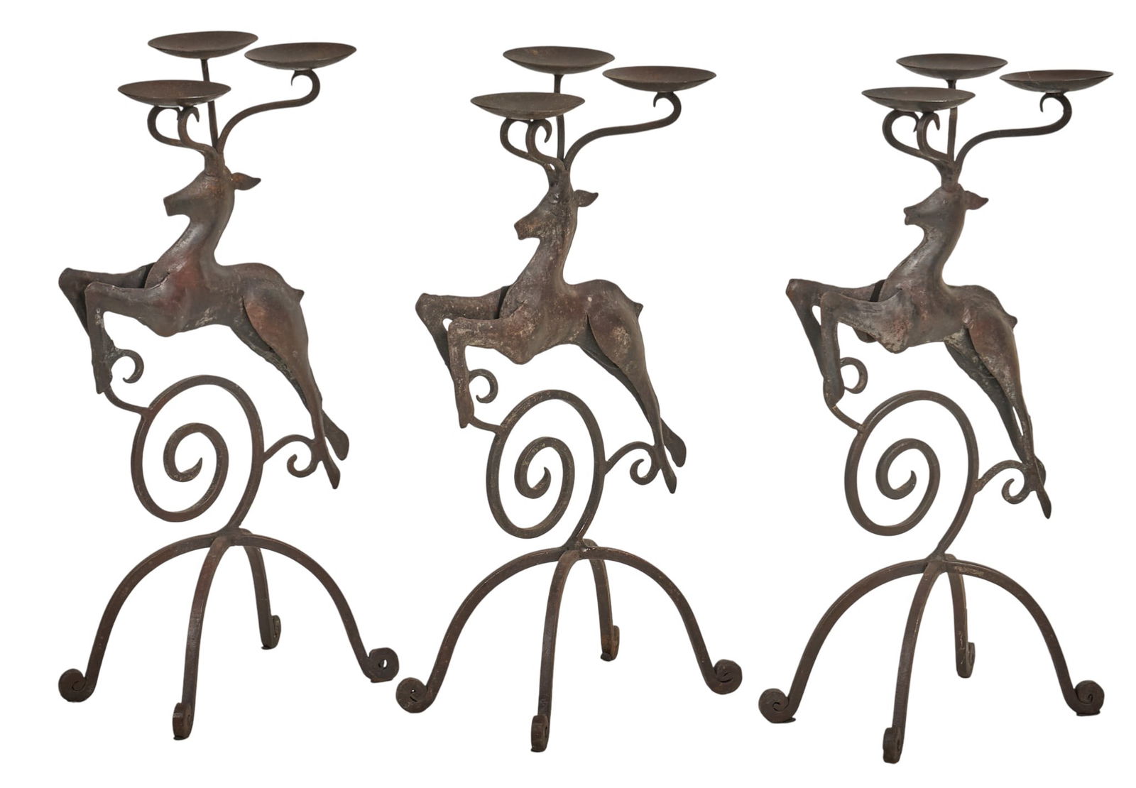 (3) Iron Stag Candelabras: Set of three iron candelabras, each with a leaping stag design and three candle platformsheight 20 in. x width 11 in. x depth 7.5 in.Provenance: Property from a home in San Antonio, Texas