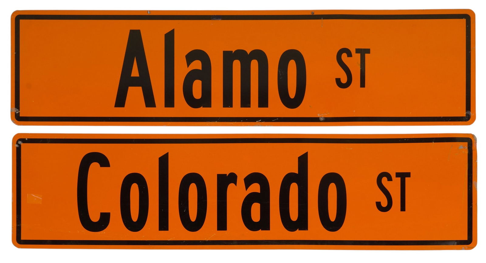 (2) Austin Surplus Street Signs: Two double-sided metal street signs from Austin Surplus, one for Alamo St. and one for Colorado St. height 6 in. x width 36 in. / eachProvenance: Property from a home in San Antonio, Texas