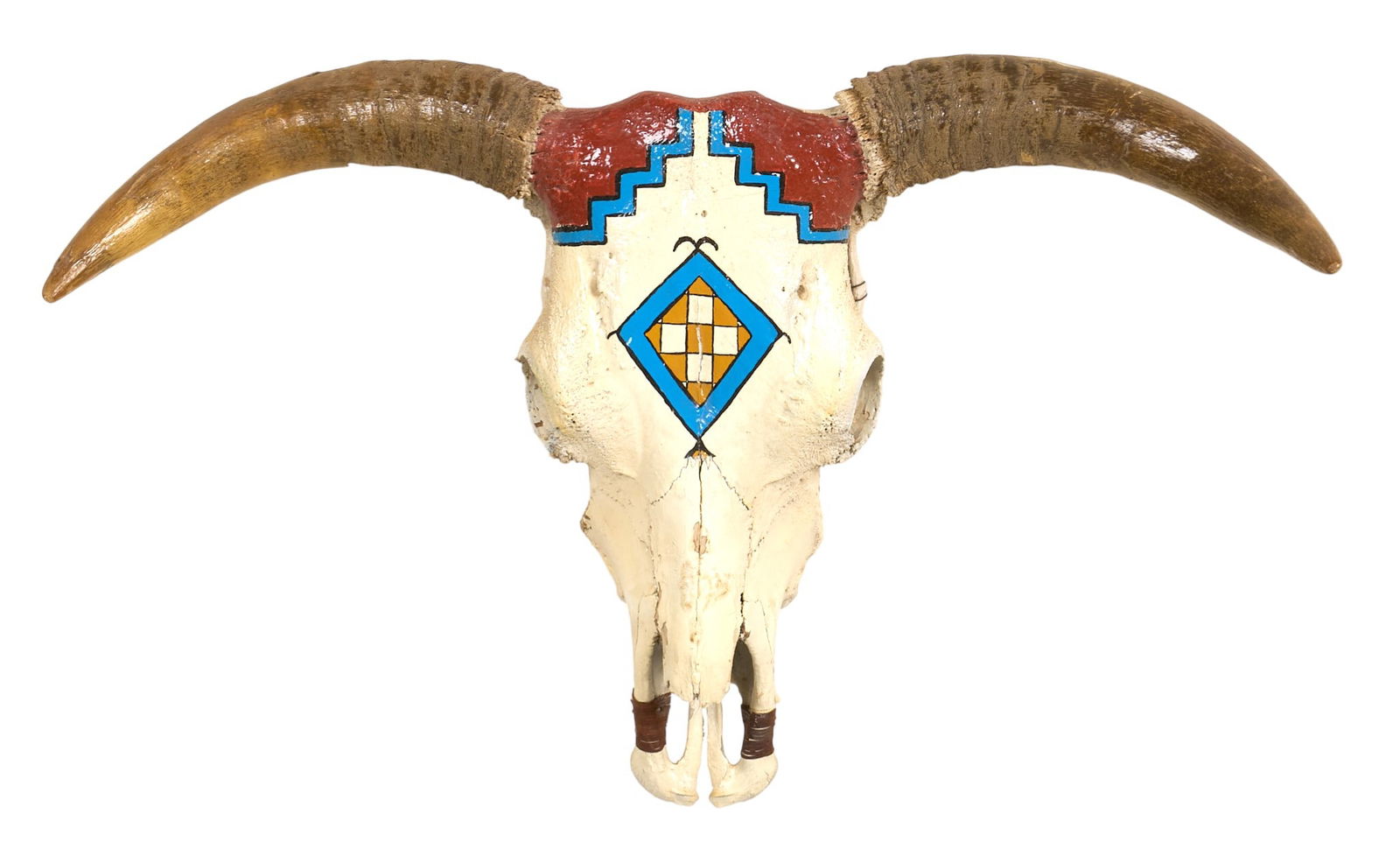 Painted Skull with Horns: Painted animal skull with horns,with geometric designs in red, blue, and yellowheight 21 in. x width 34 in. x depth 12 in. Provenance: Property from a home in San Antonio, Texas